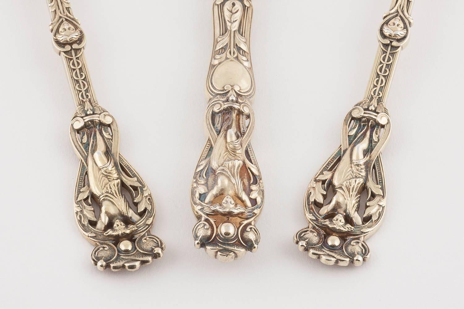 A rare example of this pattern made by Hunt & Roskell, comprising a silver gilt knife, fork and spoon the ornate handles decorated with full length maidens, foliate scrolls and pairs of putti, the blade of the knife partly engraved with scrolls.