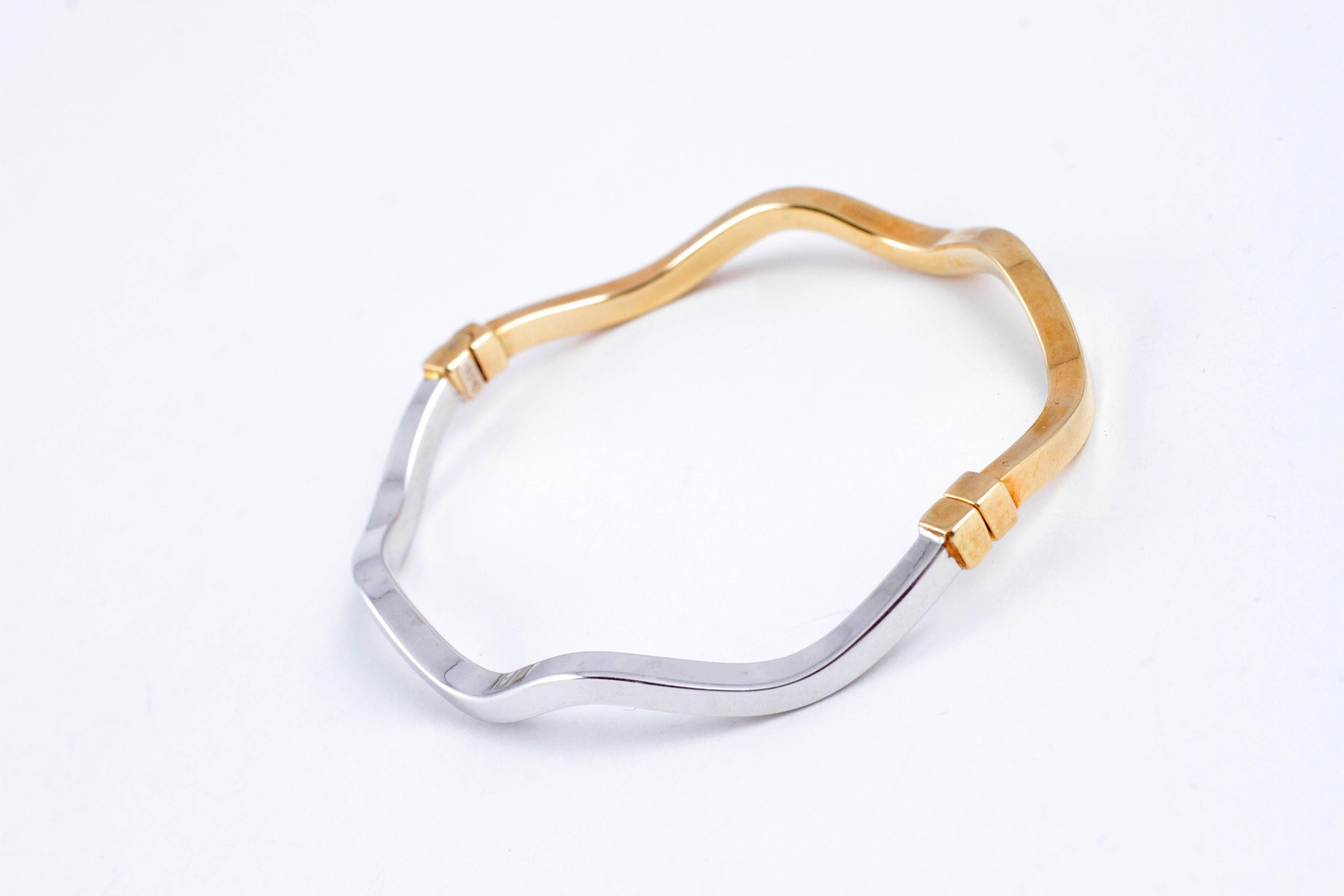 Goes with every outfit!  Layer it with any color you want - or wear it alone! 18 karat, two tone, comfy bangle bracelet. 