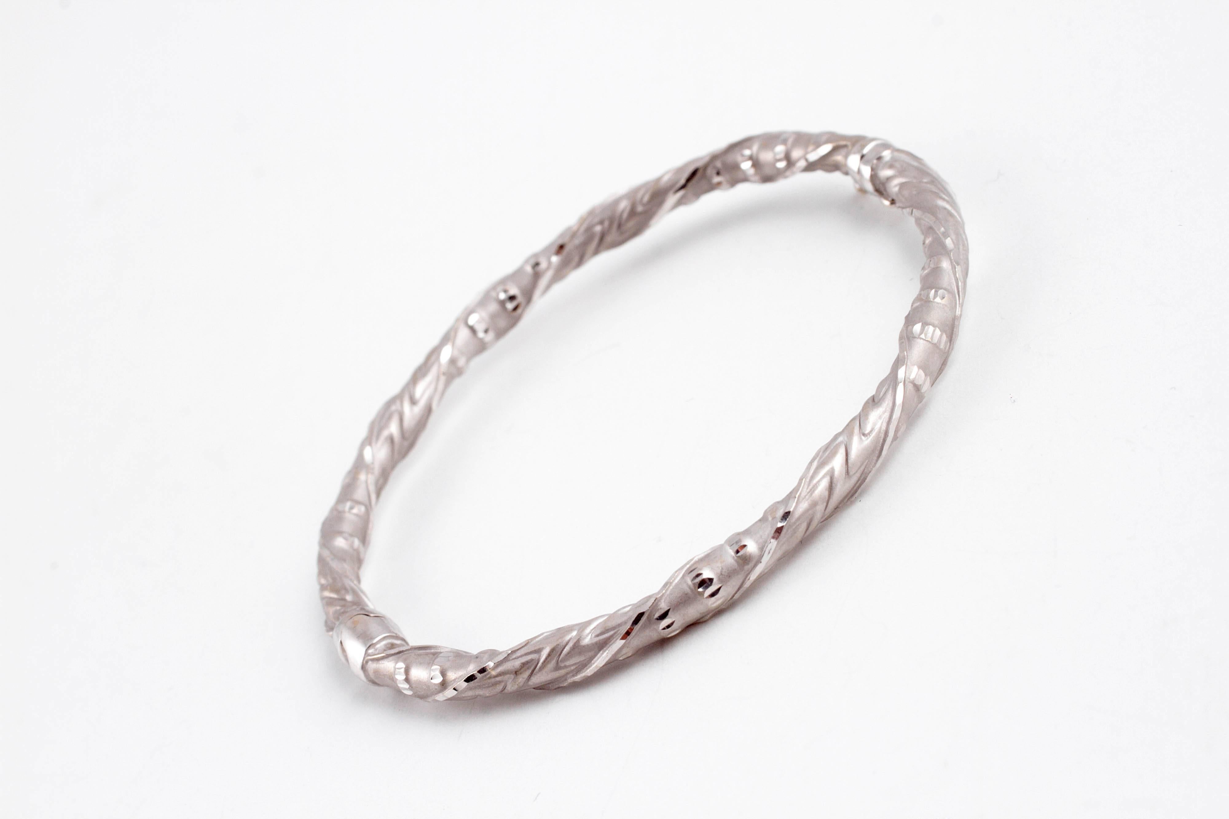 Highly-polished and matte finished, etched bangle, secured with a safety catch. Layer it or wear it alone!