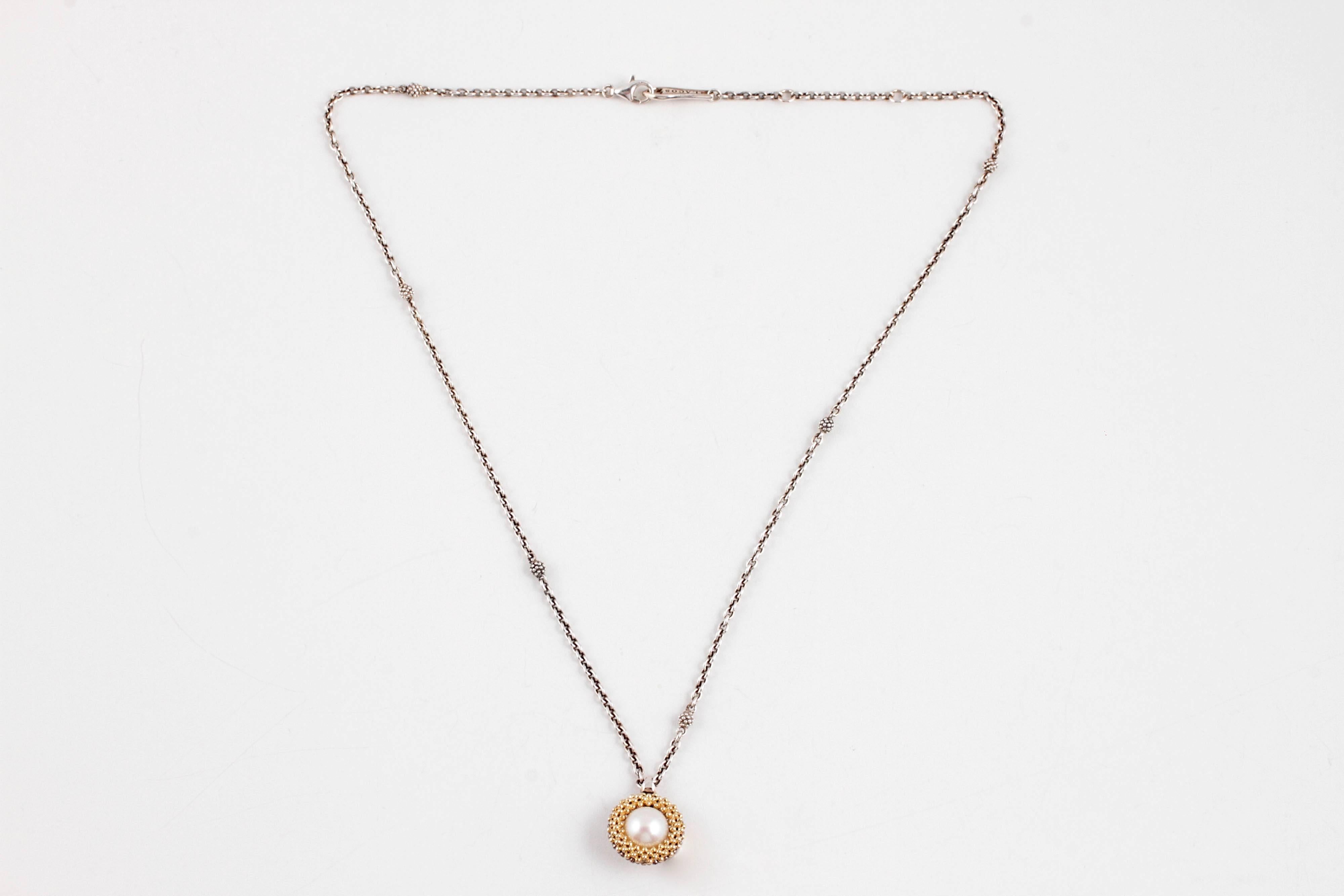 The textured bezel is 18 karat yellow gold on one side and encircles an 8.80 mm freshwater pearl.  The sterling silver chain has accent knots up and down and is secured with an easy open, lobster clasp.