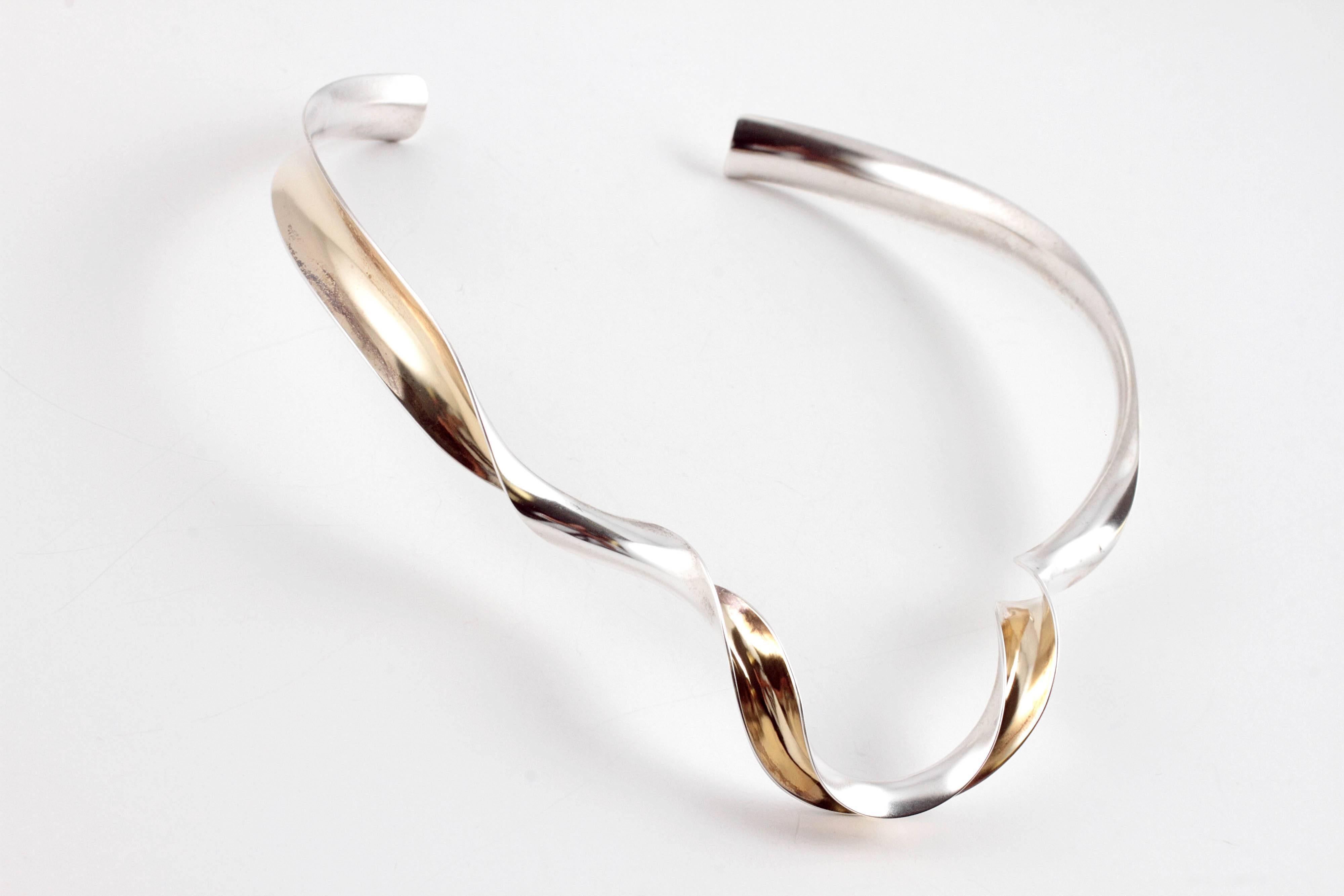 In 18 karat yellow gold and sterling silver, fun to wear and light on the neck!