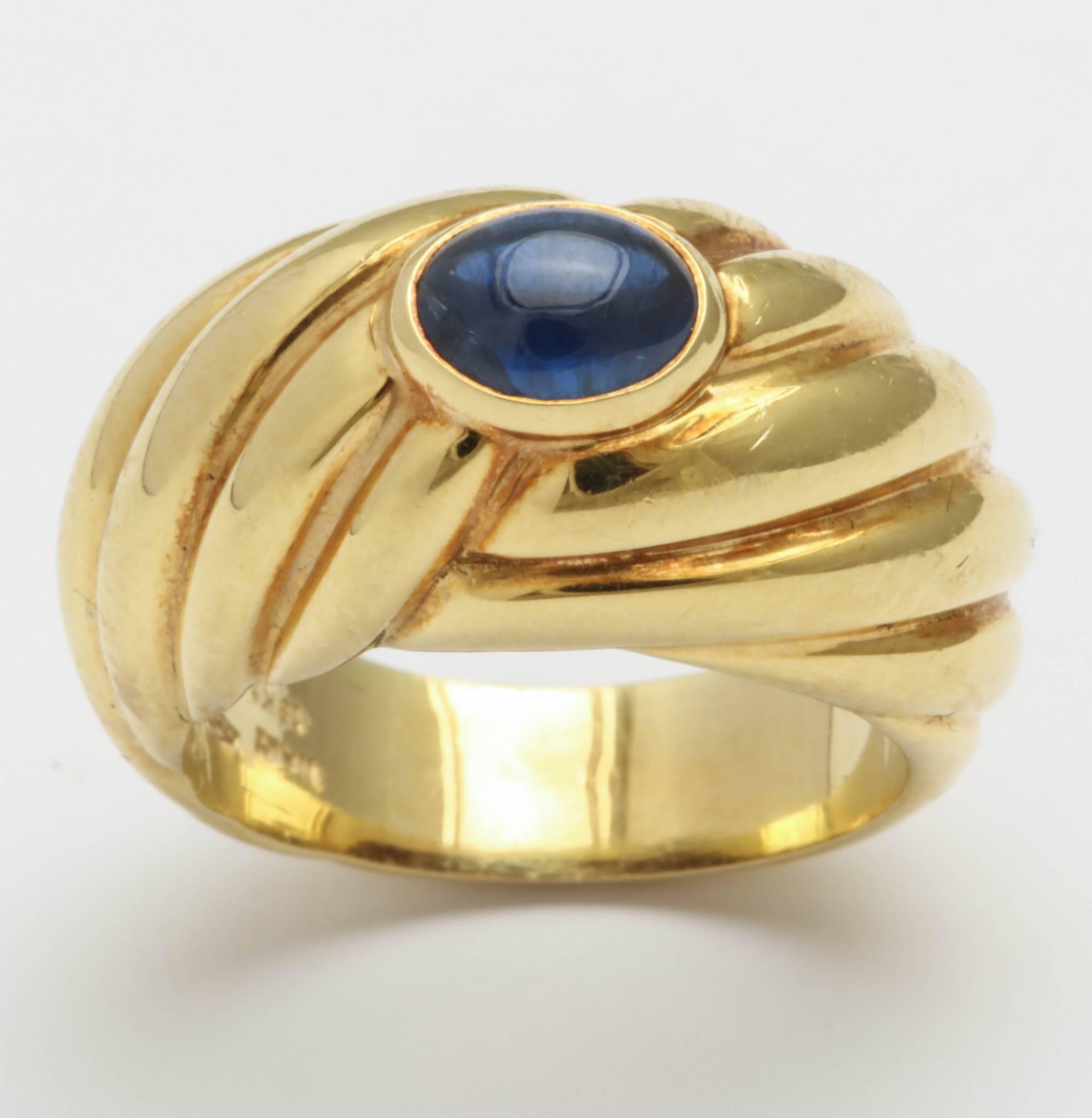 Bezel Set Cabochon Sapphire Ring set in opposing Swirl mounting.  Signed Fred - 750 and 18kt and marked Italy with Italian control marks. Size  6 1/4 but can be sized.  Truly a modern updated setting.