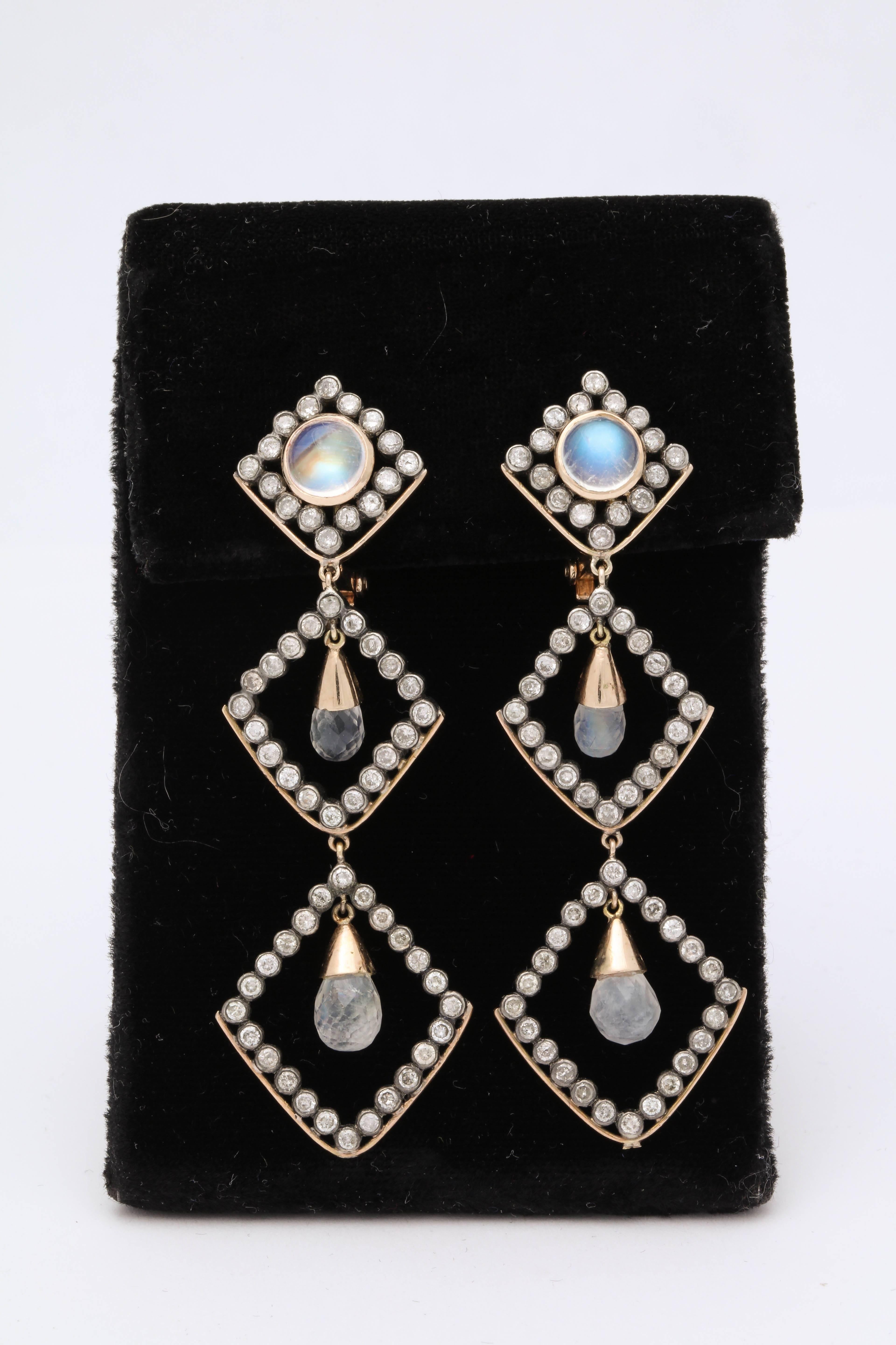 One Pair Of Triple Triangular Shaped Dangle Earrings Composed Of Six Moonstones And With Numerous Antiqe Cut Diamonds. Note All Diamonds Set In Silver With 14kt Gold Clip On Backs and 14kt Gold Posts. Made In The 1960's In America.