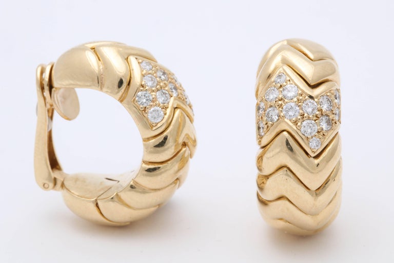 One Pair Of Ladies Clip On Earrings Designed With An 18kt Yellow Gold Chevron Style Gold Workmanship. Each Earring Is Further Embellished With One Carat Of Full Cut High Quality Diamonds. Total Diamond weight Approximately Two Carats, Made In