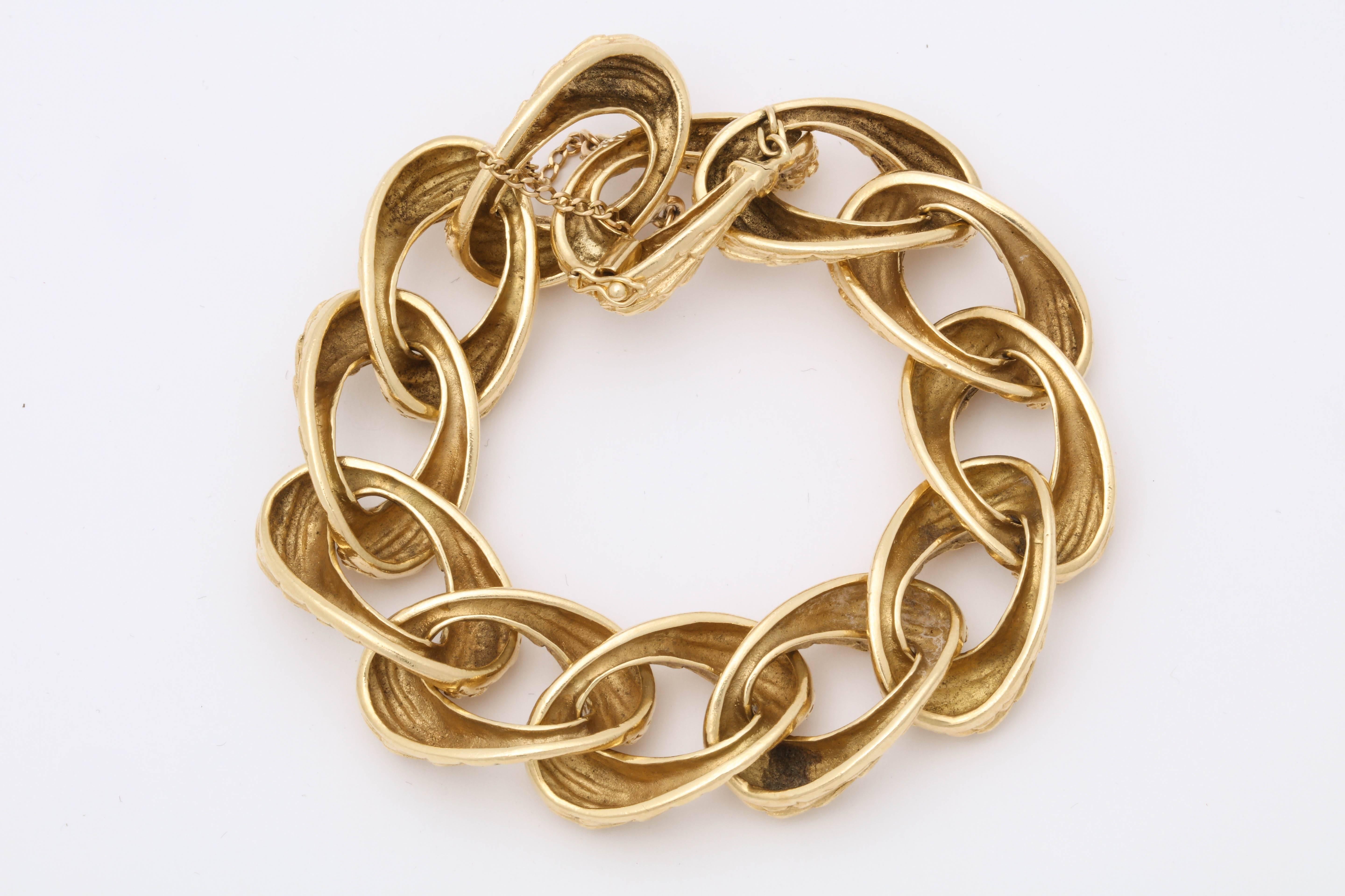 One Unisex Open Link Bracelet Crafted In 18kt Textured Gold Links. Created To Emulate A Bamboo Style Branch Like Texture This Bracelet Is A Very Beautifully Made Piece. Designed In The 1970's In America.NOTE: SAFETY CHAIN For Extra Security Made In