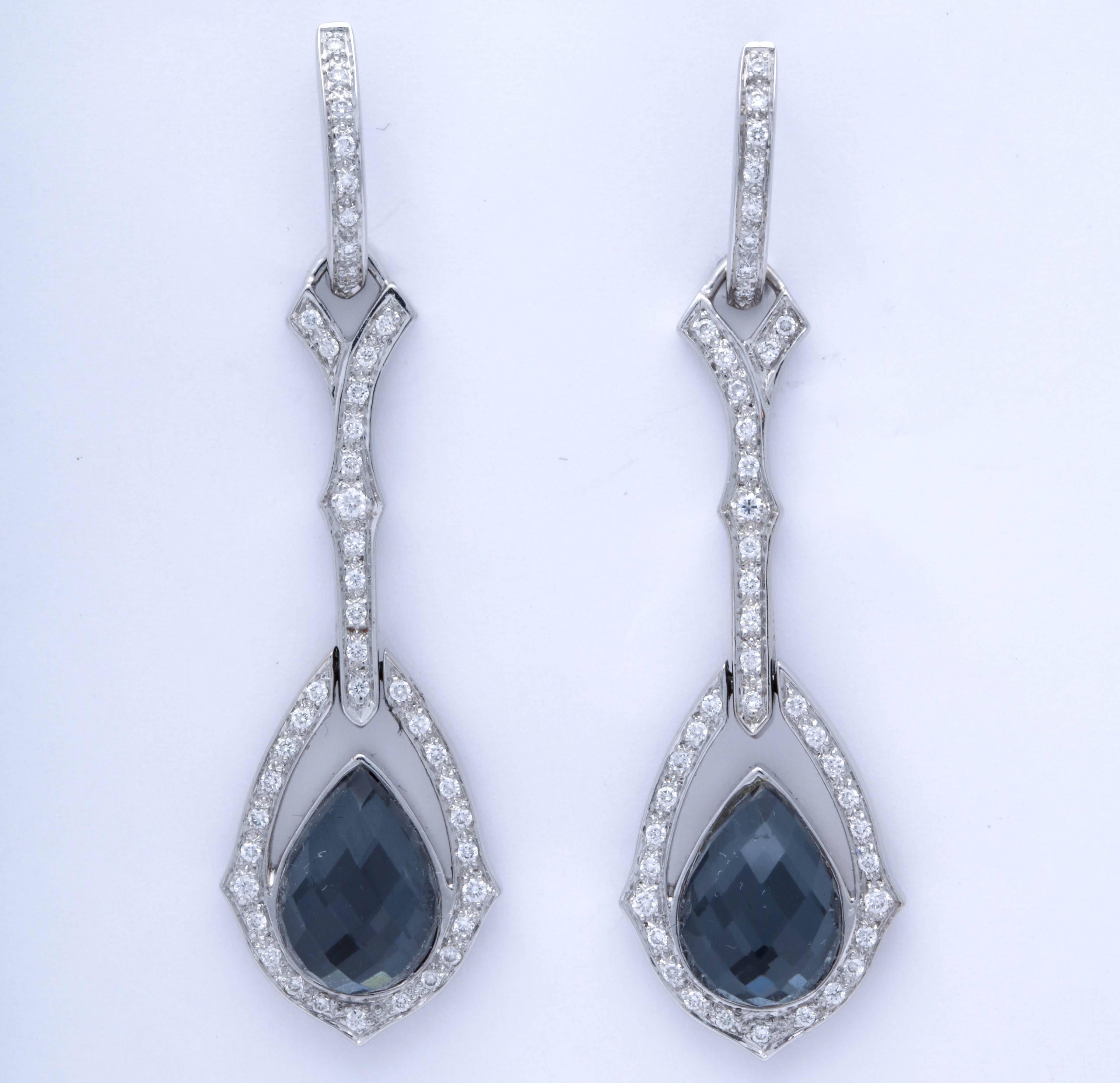 From the Romantic Crystal Haze Collection by English Jeweler, Stephen Webster - a Pair of Convertible Length drop Earrings set in 18kt White Gold and set with a Faceted teardrop shaped crystal Haze Quartz Stone.
Earrings can be worn with Diamond