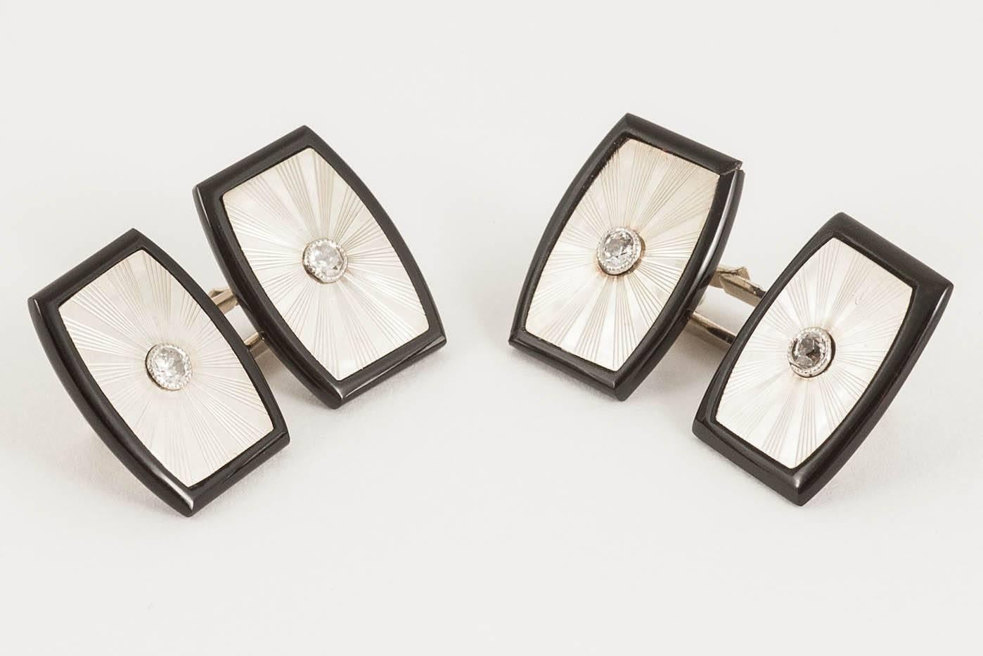 Pair of 18ct white gold mounted onyx cufflinks,the face engraved with a small diamond centre stone,English c,1950