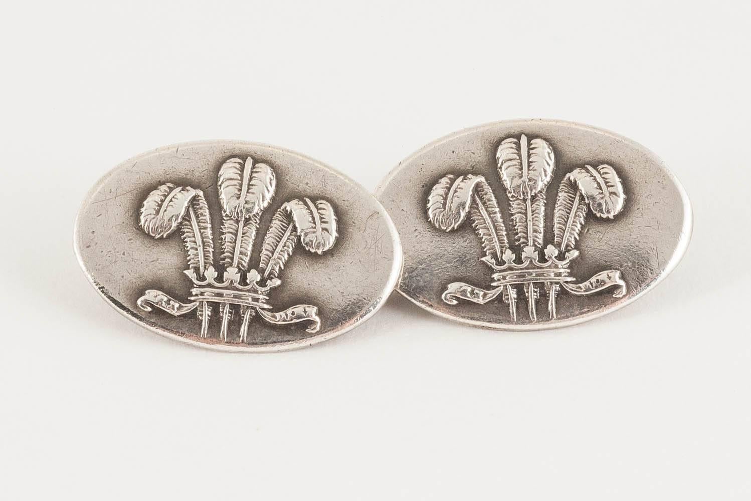 Pair of oval, double sided silver cufflinks,with the Prince of Wales feathers in a raised design,hallmarked for Chester 1962 . Size 12 x 19 mm