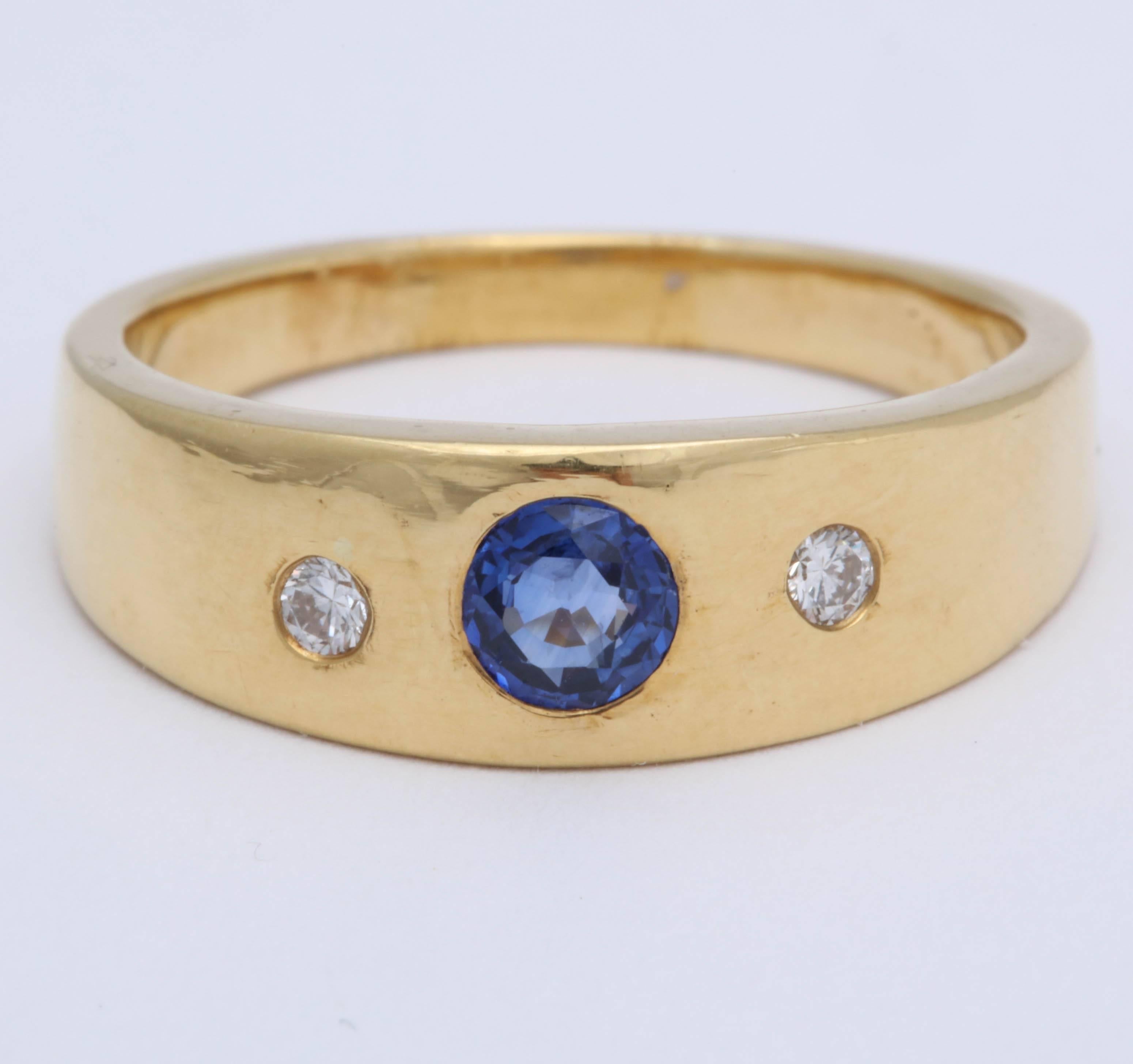 This 18 Kt ring can be used as a wedding band or a stacking ring. The blue sapphire  is about .85 cts., and a slightly oval faceted stone that is 