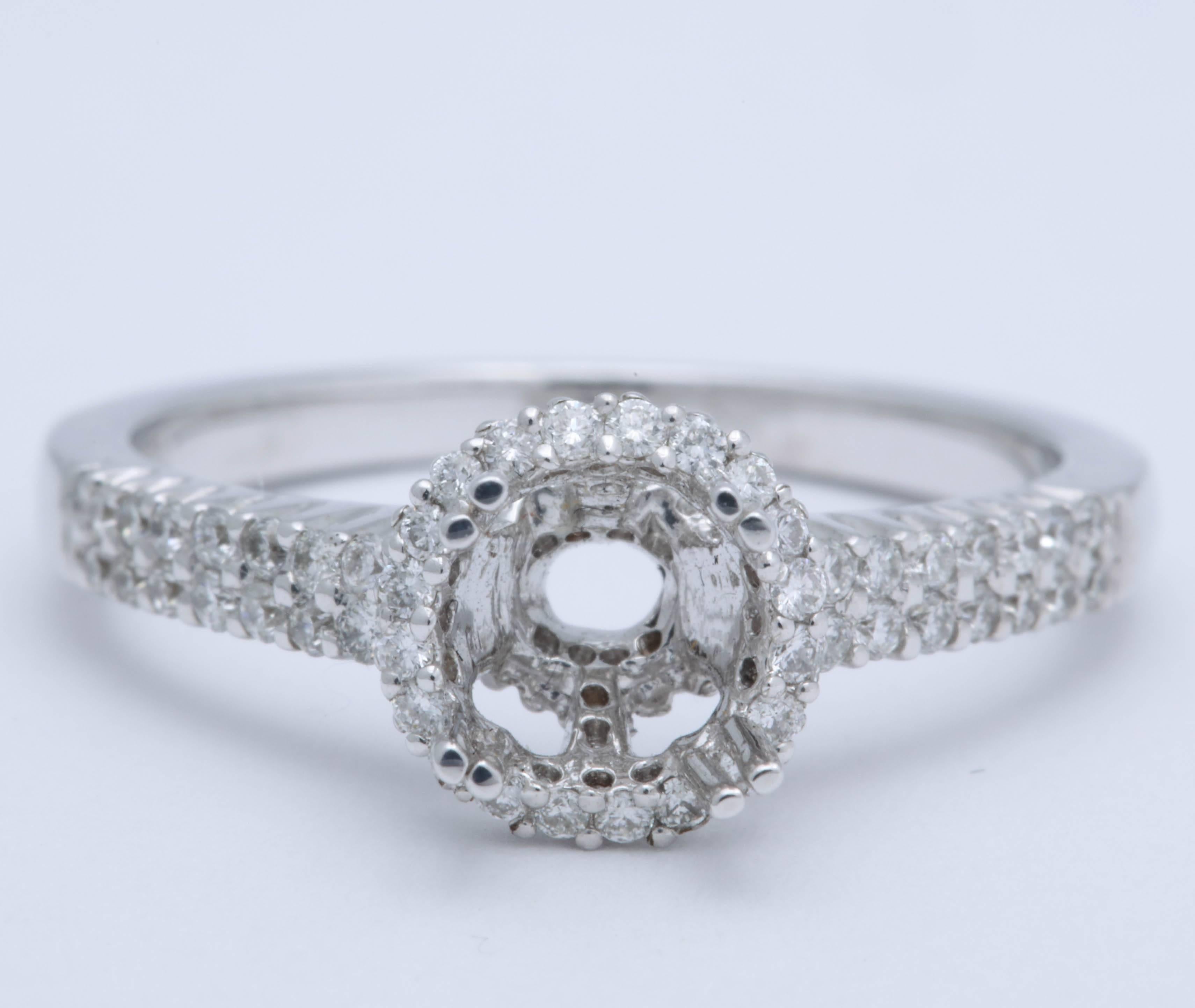 This mounting is 18 kt white gold and has 1 ct  microset diamonds set in a Halo style.. It can be set with a center stone between .75 ct to 1.25 ct.  The ring is 6 3/4 and can be sized. A great setting to modernize your engagement ring or for a new