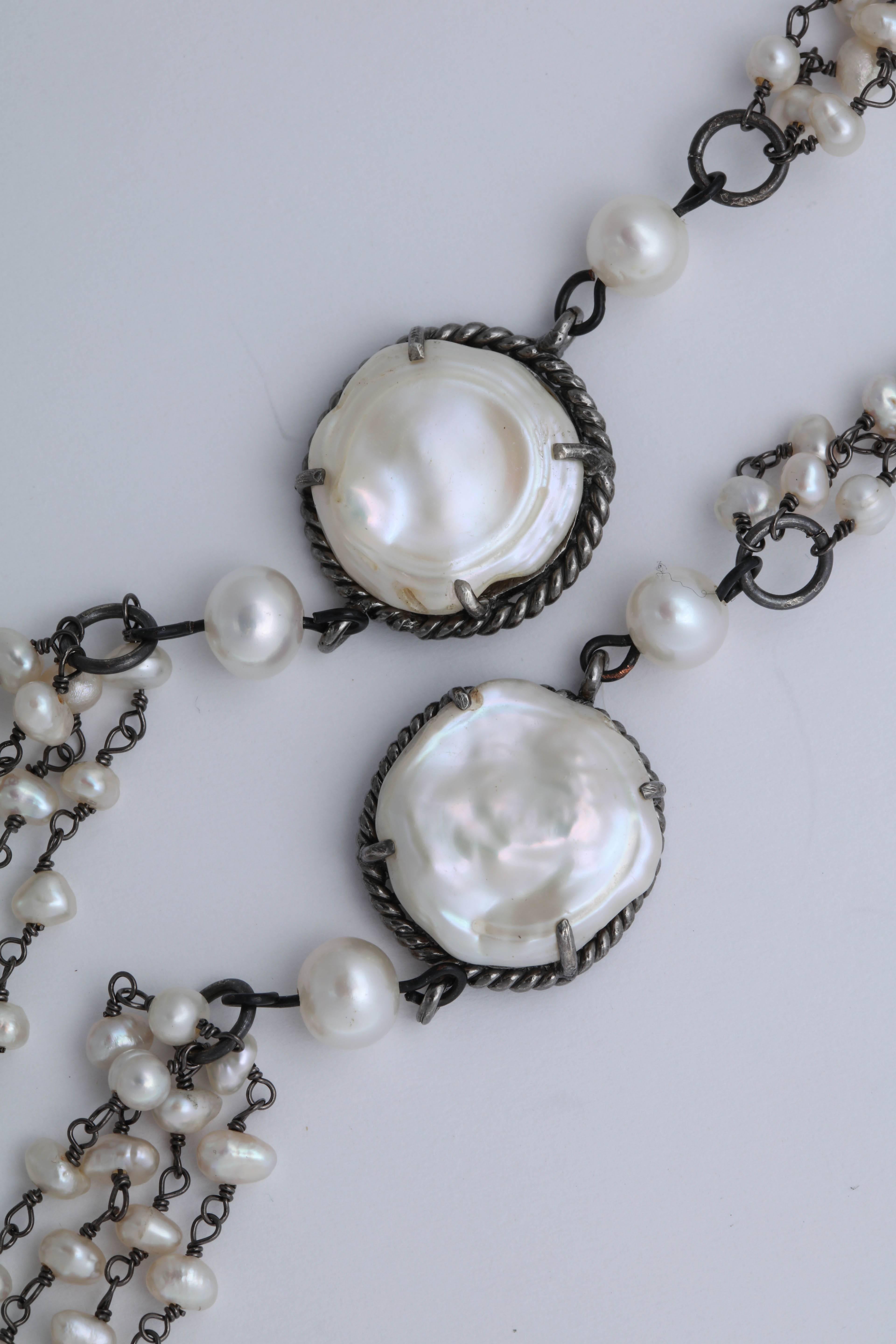 This necklace is 3 rows of 'wrapped' fresh water pearls with 2  silver stations with 3/4 in. coin pearls. The total length of the necklace is 40 in.