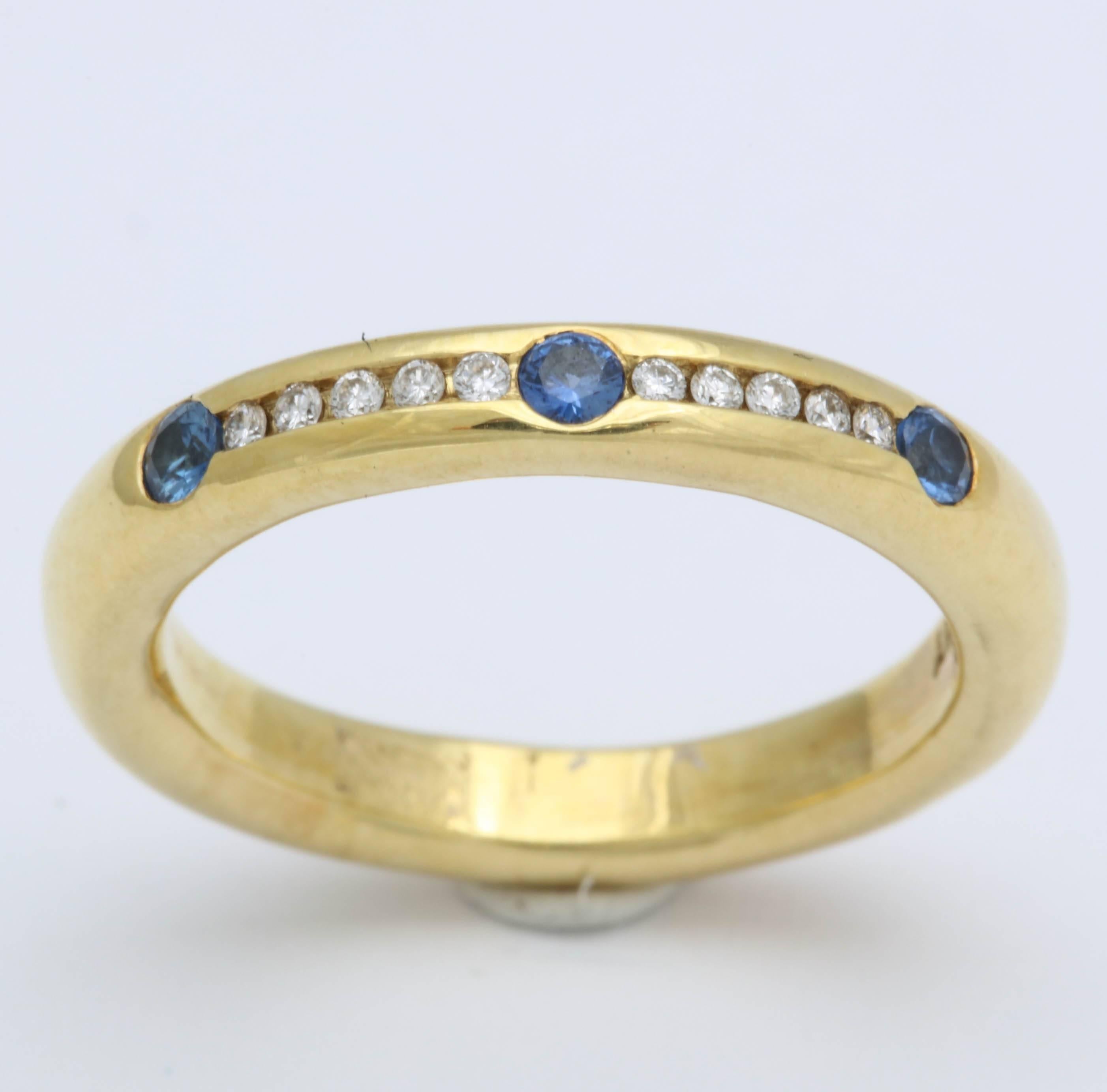 This ring is 18 kt yellow gold with a row for sapphires and diamond. The band can be used for a wedding band or as a stacking ring. The shape of the ring is called a 