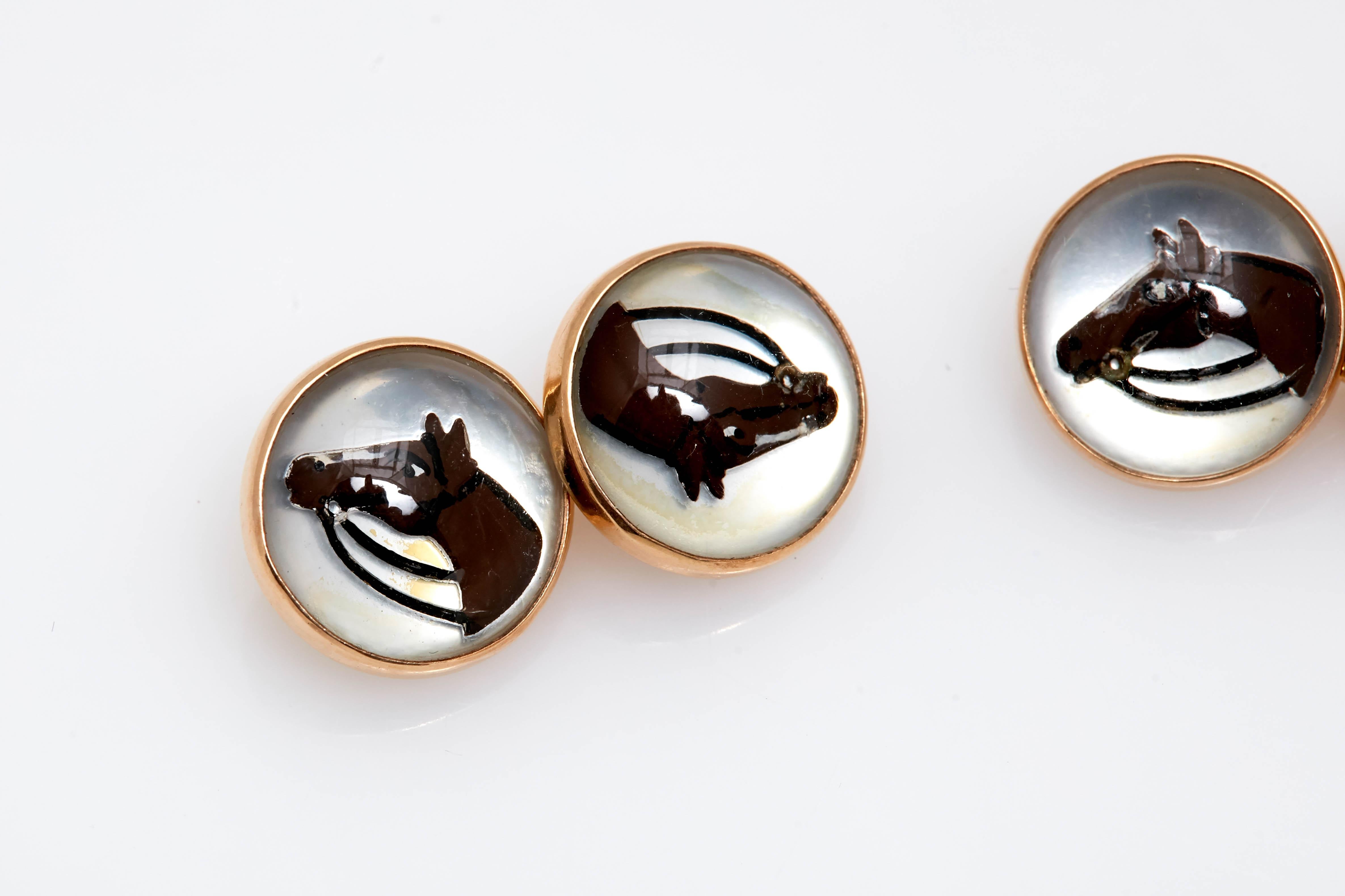 A pair of cufflinks in 14kt yellow gold with horse enamel decorations. Made in the United States, circa 1950