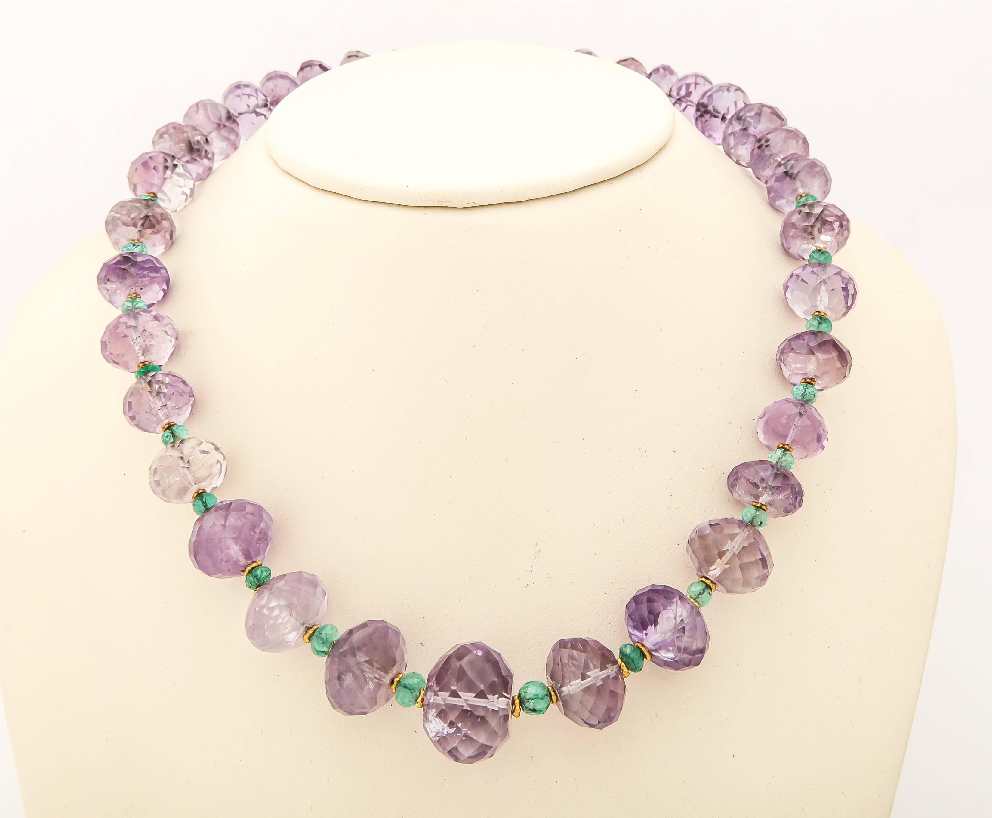 Large faceted light purple amethyst beads a strung with faceted emerald beads and 18 kt gold daisy beads in between, a classical and elegant combination.The easy to manage toggle clasp is also 18 kt.  The largest amethyst bead is approximately 1