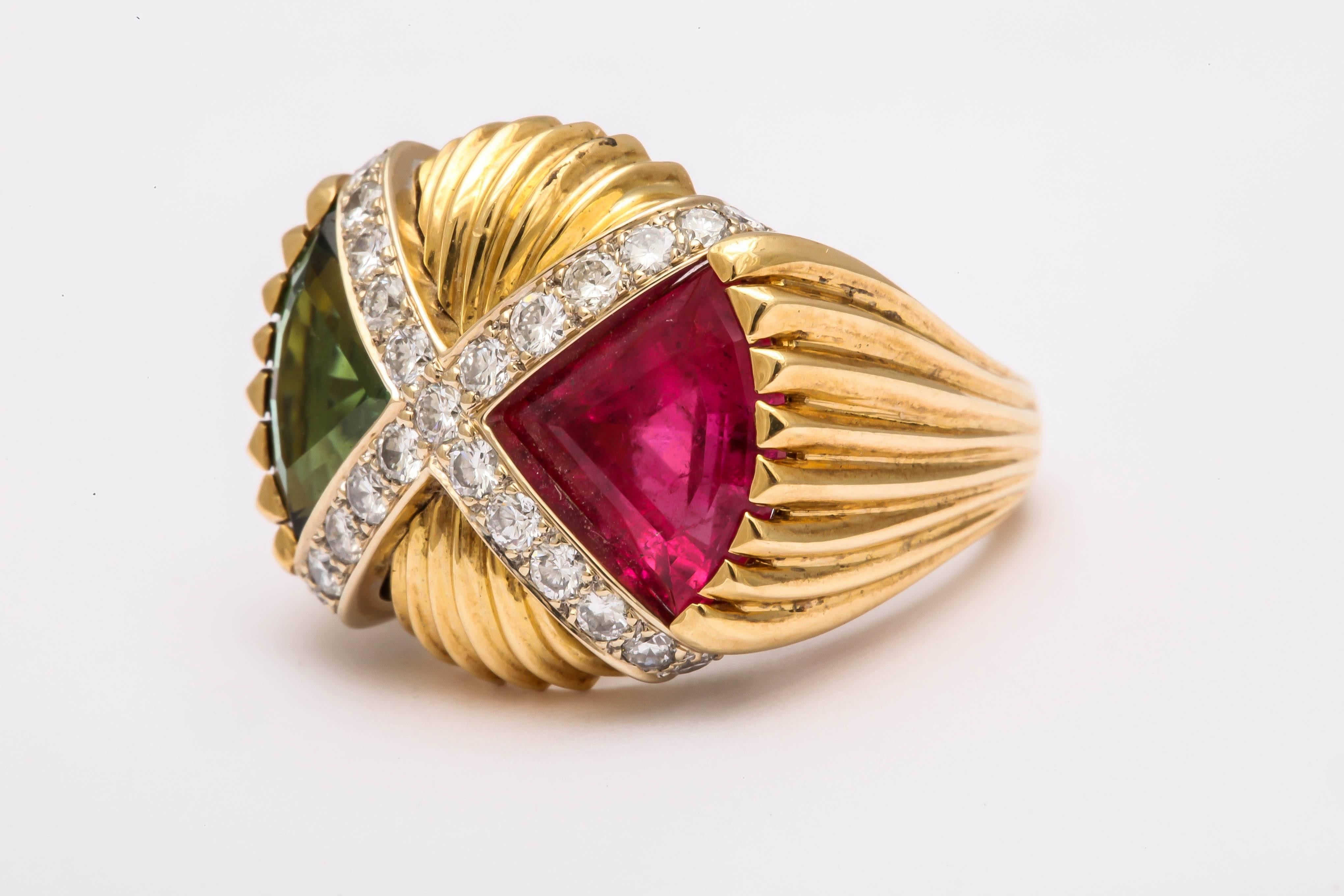 Exquisite hot pink and bright green pie slice shaped tourmaline ring. This unique ring is 18 kt gold plus 1.02 cts with diamond set pave set in 18 kt white gold in an 'X' pattern dividing the tourmalines, weighing 13.56 cts for the pair.  This ring