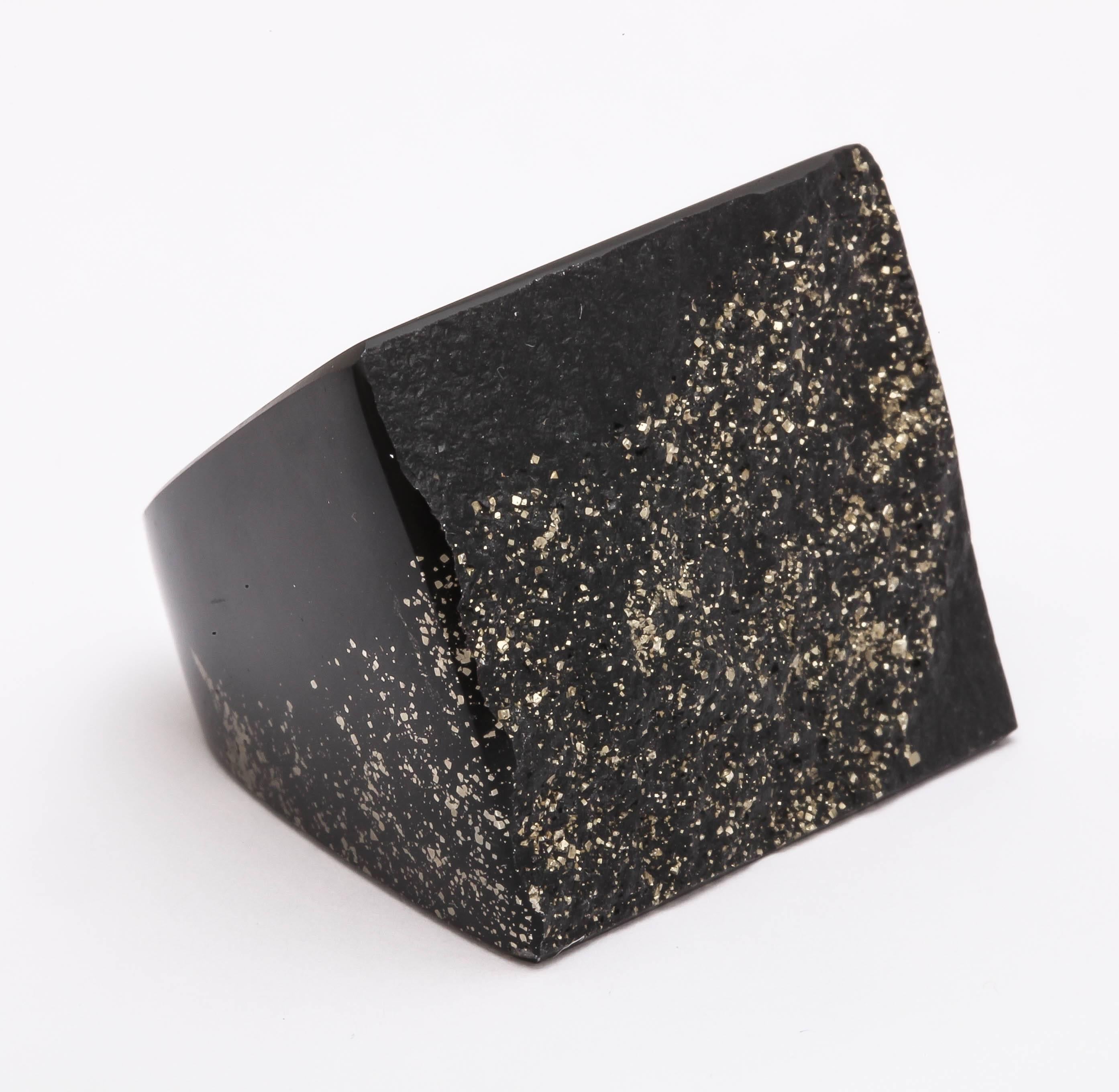 This ring is carved from Black Swiss marble with a galaxy of fool's gold (iron pyrite) sparkling 'stars' floating in the dark background. The ring size is 7/8.  This size of the top is about 35 mm wide and 30 mm high. A very unique, one of a kind