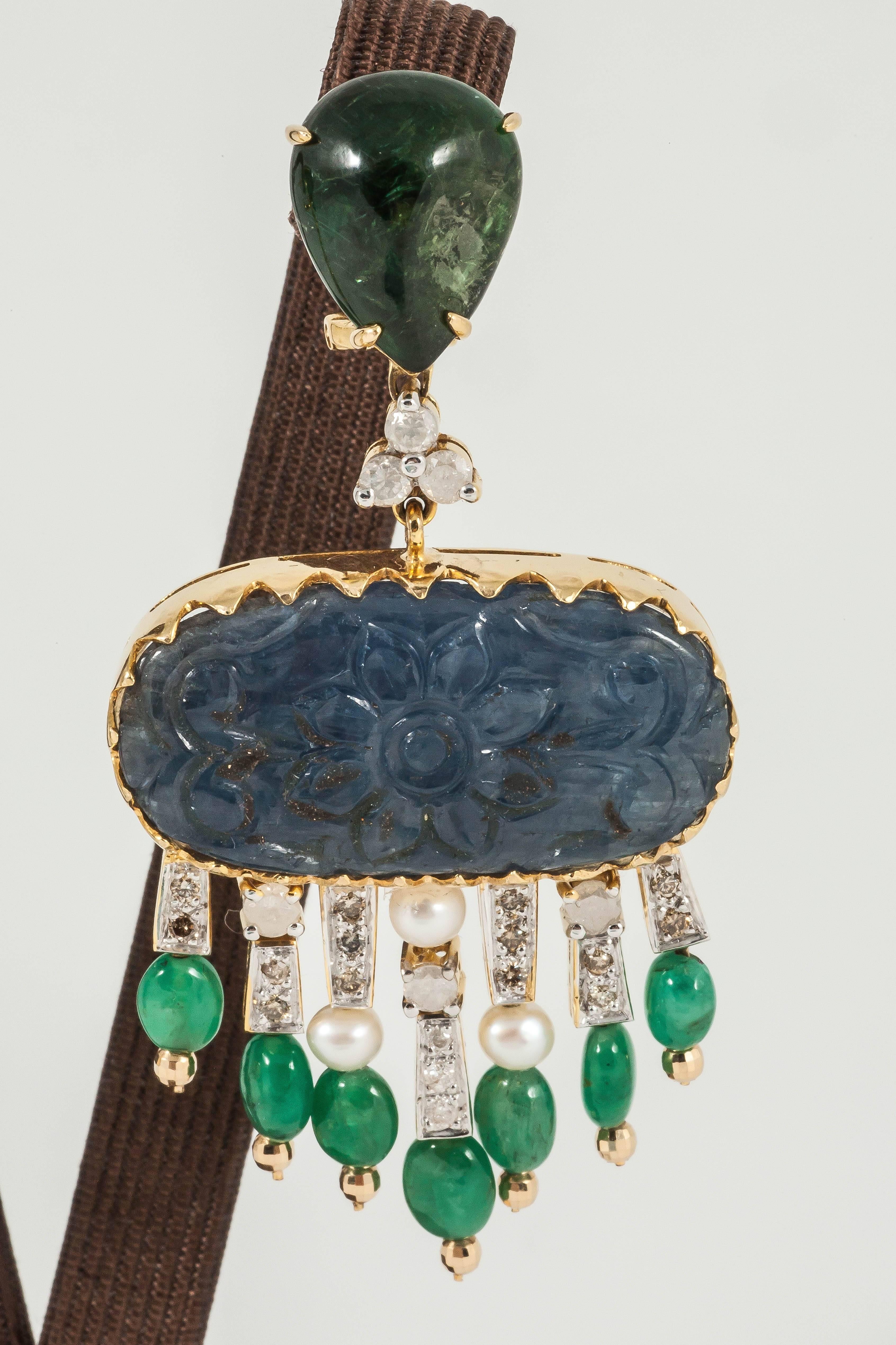 Carved blue Sapphire earrings adorned with Green Tourmaline  along with Diamond and Emerald drop tassels

18K White Gold: 22.7gms
Carved Sapphire: 44.54cts
Turmoline: 7cts
Diamond: 1.45cts
Emerald drop: 8.85cts
Pearl: 6pcs
