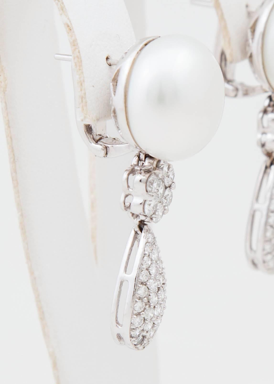 These beautiful White South Sea and Diamond earrings make quite the statement! They consist of 16x17 natural color White South Sea cultured pearls and 2.86ct of white diamonds that hang from the pearl set in platinum. These earrings have an omega