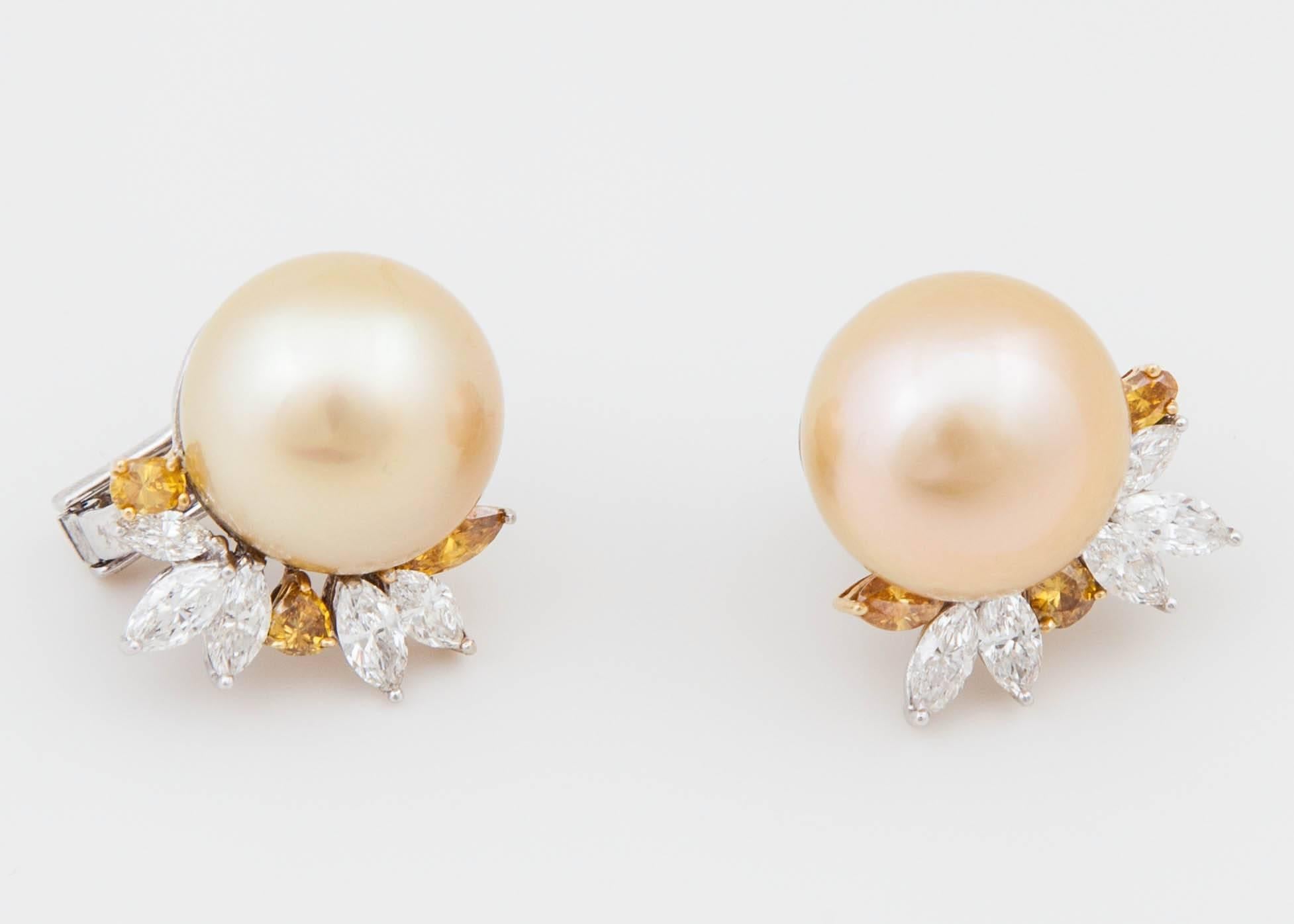 These natural color Golden South Sea cultured cocktail style pearl earrings are perfect for the holiday season. 1.79 carats of GH SI white diamonds and .90 carats of GH SI yellow diamonds fan out to decorate lustrous 15x16 natural color Golden South