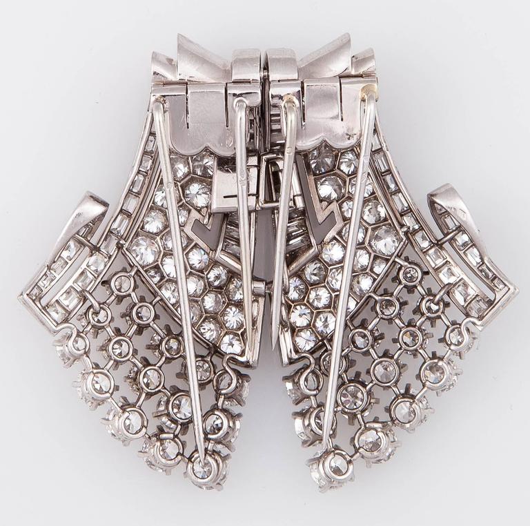 Art Deco Platinum and 30.00 carats Diamond Double Clip Brooch. Bright polished platinum with sparkling diamond sprays create stunning, multi-dimensional, sculptural works of wearable art.