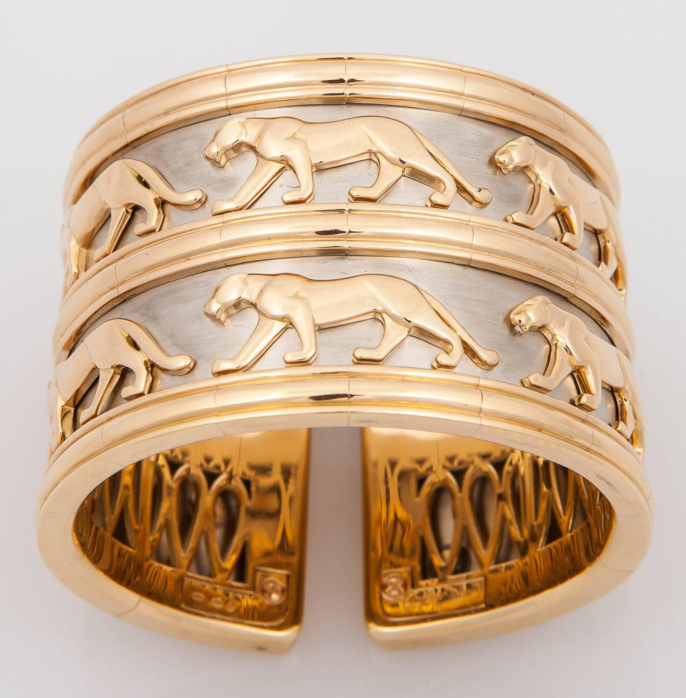 This incredibly rare Vintage Cartier Panthere  Bracelet.  It is  finely decorated with the iconic Cartier Panthere design in 18k Yellow Gold, set on a white metal. The bracelet cuff however has two rows of the Panthere design.