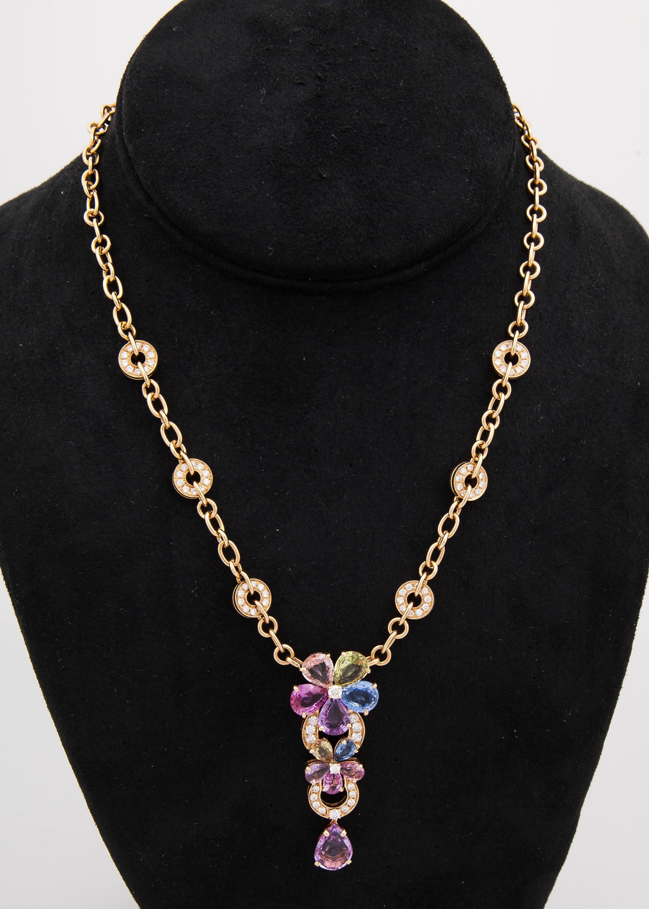 Lovely BULGARI Necklace is  designed as a stylized flower, decorated with multi-colored Sapphires weighing approx. 11.53 carats and round-shaped brilliant cut diamonds weighing approx. 2.25 carats, mounted in 18k yellow gold.