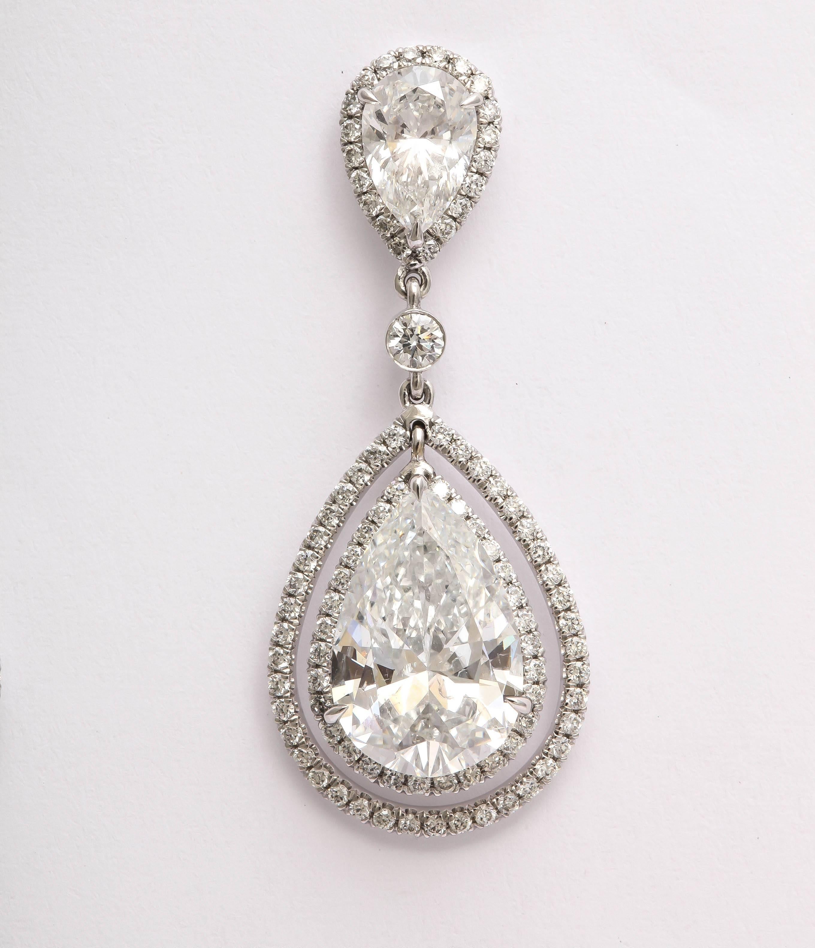 Amazing diamond  pear shaped dangling earrings. They are made in 18 kt white gold with a post. The top 2 pear shapes are 1.58 ct  for the pair, and are a G color, SI 1 clarity. The large bottom pear shapes  are 6.54ct for the pair and are F color,