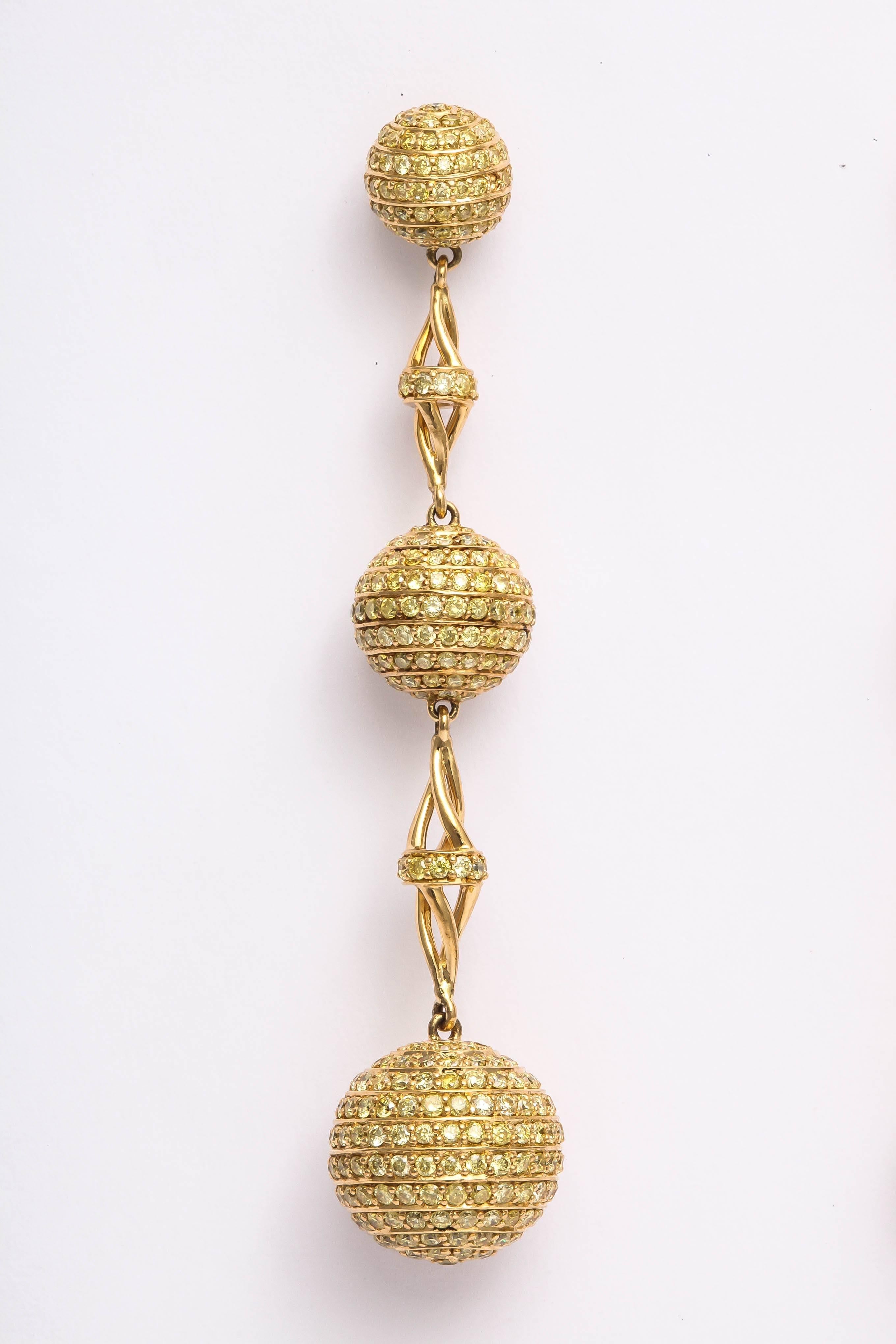 These sensational dangling earrings are made in 18 kt yellow gold and are  beautifully pave set with 966 ( that's right, 966 individual diamonds )fancy yellow color,  brilliant cut melee. The yellow diamonds are VS clarity and the total weight is