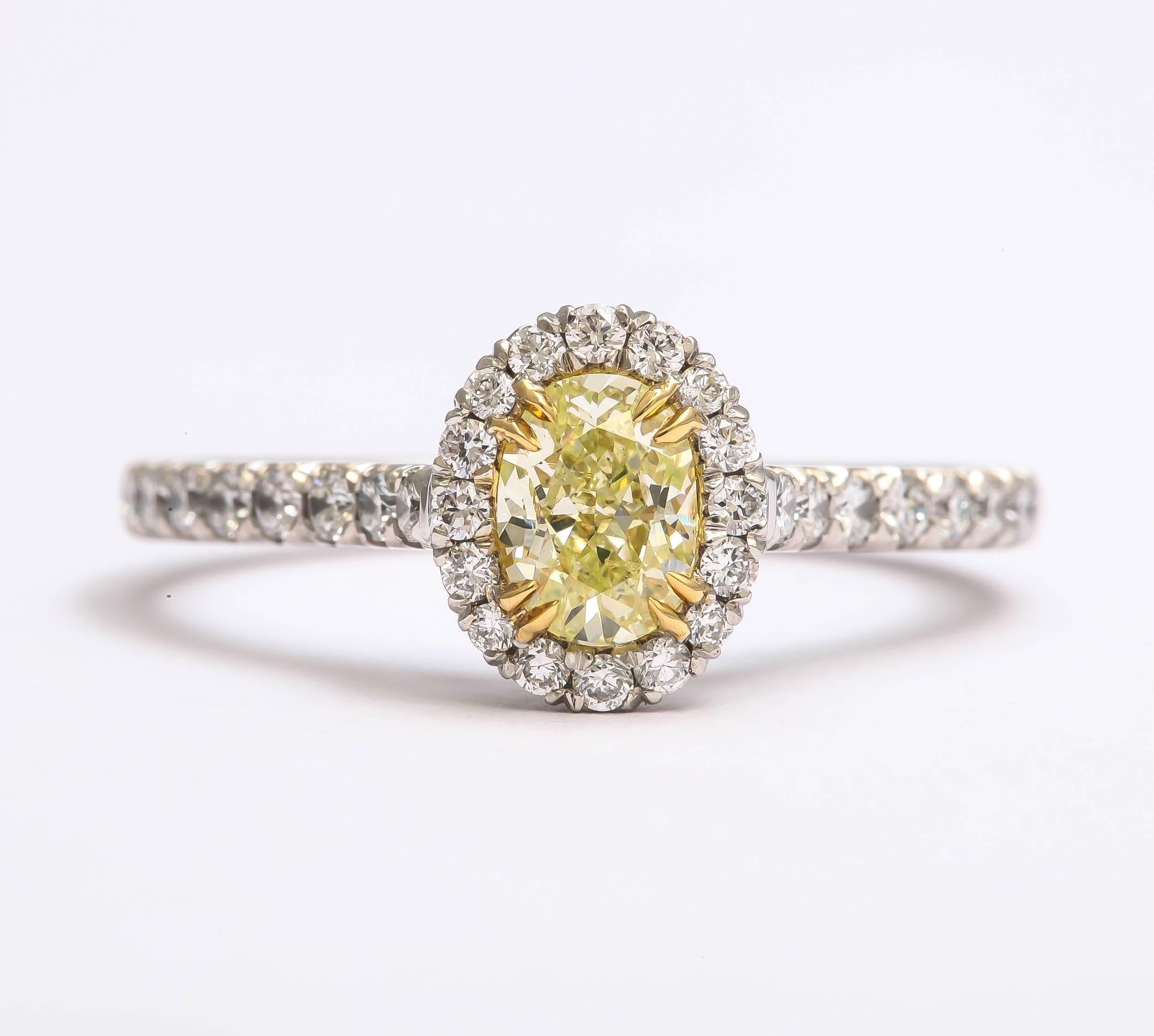 This unique fancy yellow green oval diamond  weighs .58 cts. The total weight of diamonds in the ring is 1.10 cts. The 42 white diamonds surrounding the oval, weigh .52 ct , they are G color, SI 1 clarity and are set in a halo style. The ring is