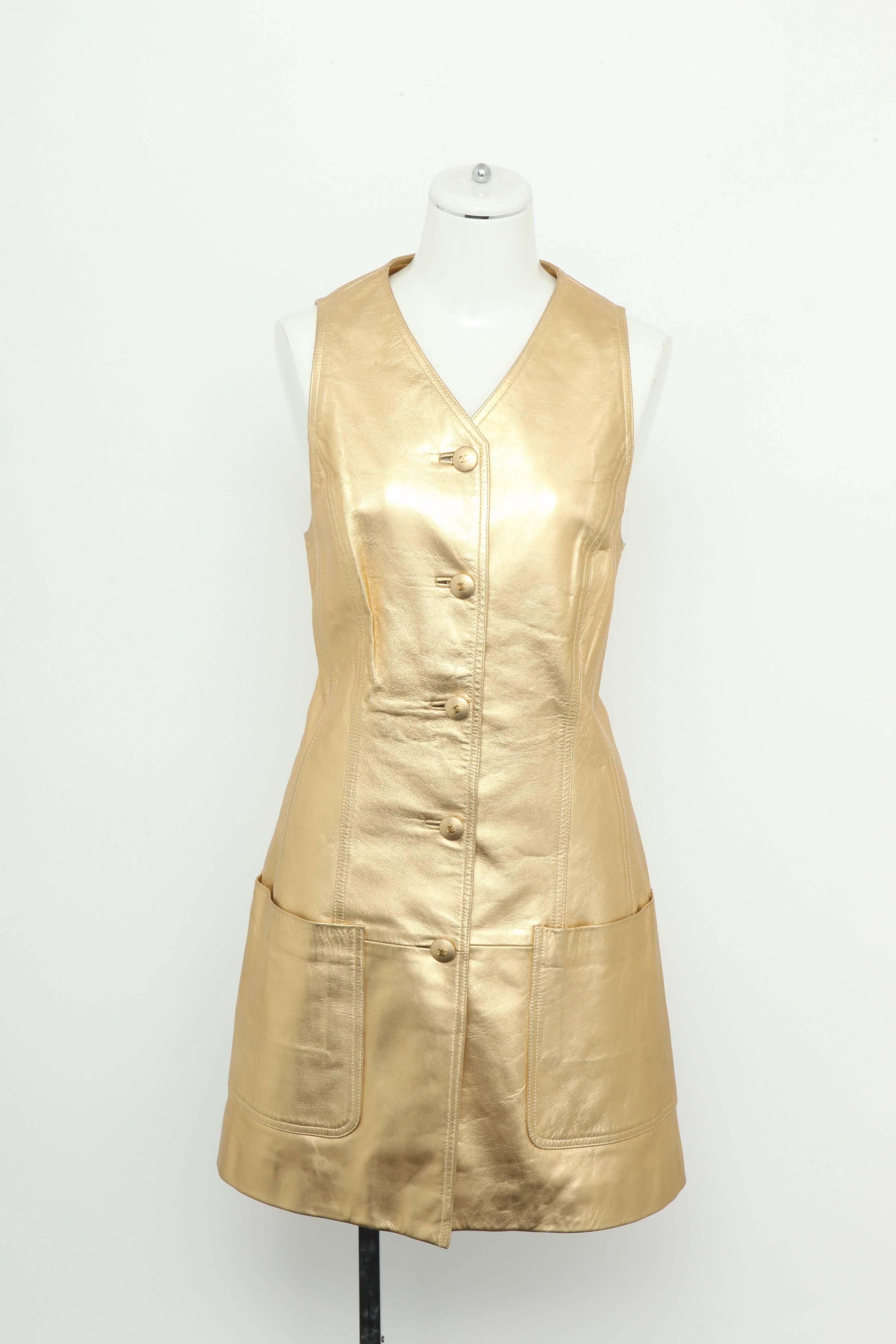 Extremely rare Chanel Gold leather vest dress with CC Buttons. From the 1980's. Belt sold separately.

Size 40
Shoulders: 15 inches
Bust: 14.5 Inches
Waist: 16 Inches
Hip: 32 Inches
