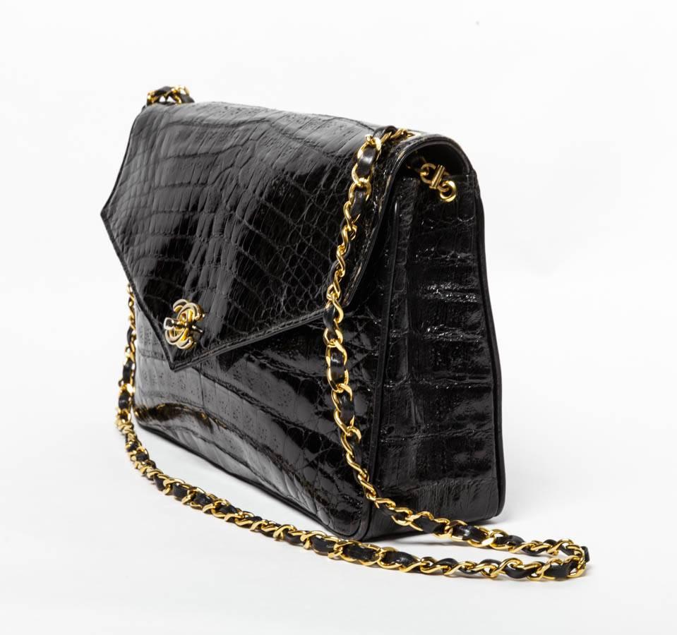 Chanel Vintage Black Crocodile Flap Bag with gold hardware. Single flap with two interior pockets. Strap drop is 18 inches.
Hologram reads 