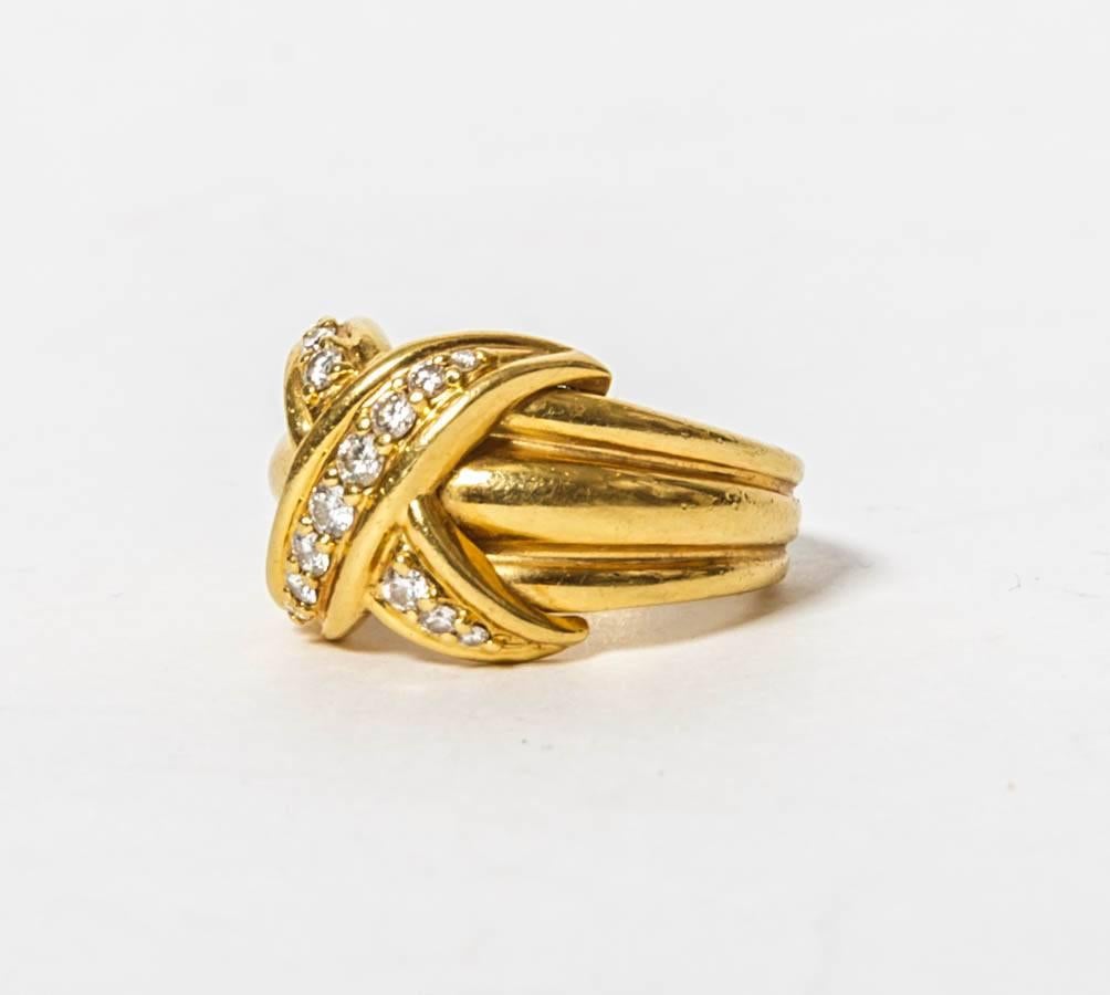 
1990 Tiffany & Co Large 18k Yellow Gold Signature X Kiss Ring with Diamonds. This is the largest ring of the signature series weighing 12 grams.
.4 carats in diamonds.
Size 6.
Comes with original pouch.