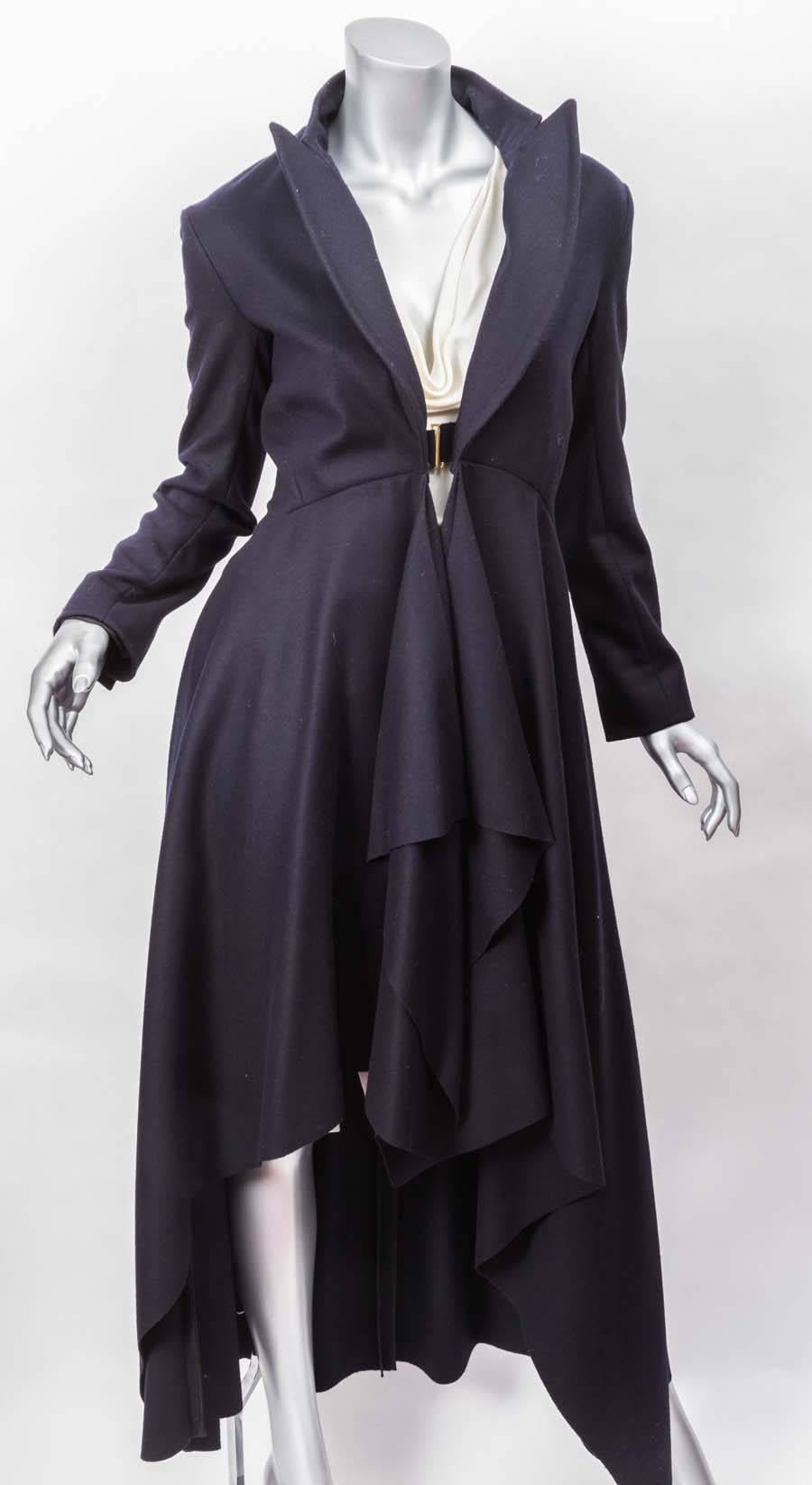 Stunning Celine Navy Blue Long Draped Wool Coat with cascading high low hem and front hook closure. Lined partially in silk. Side pockets and inverted pleat back.
New with original tags.