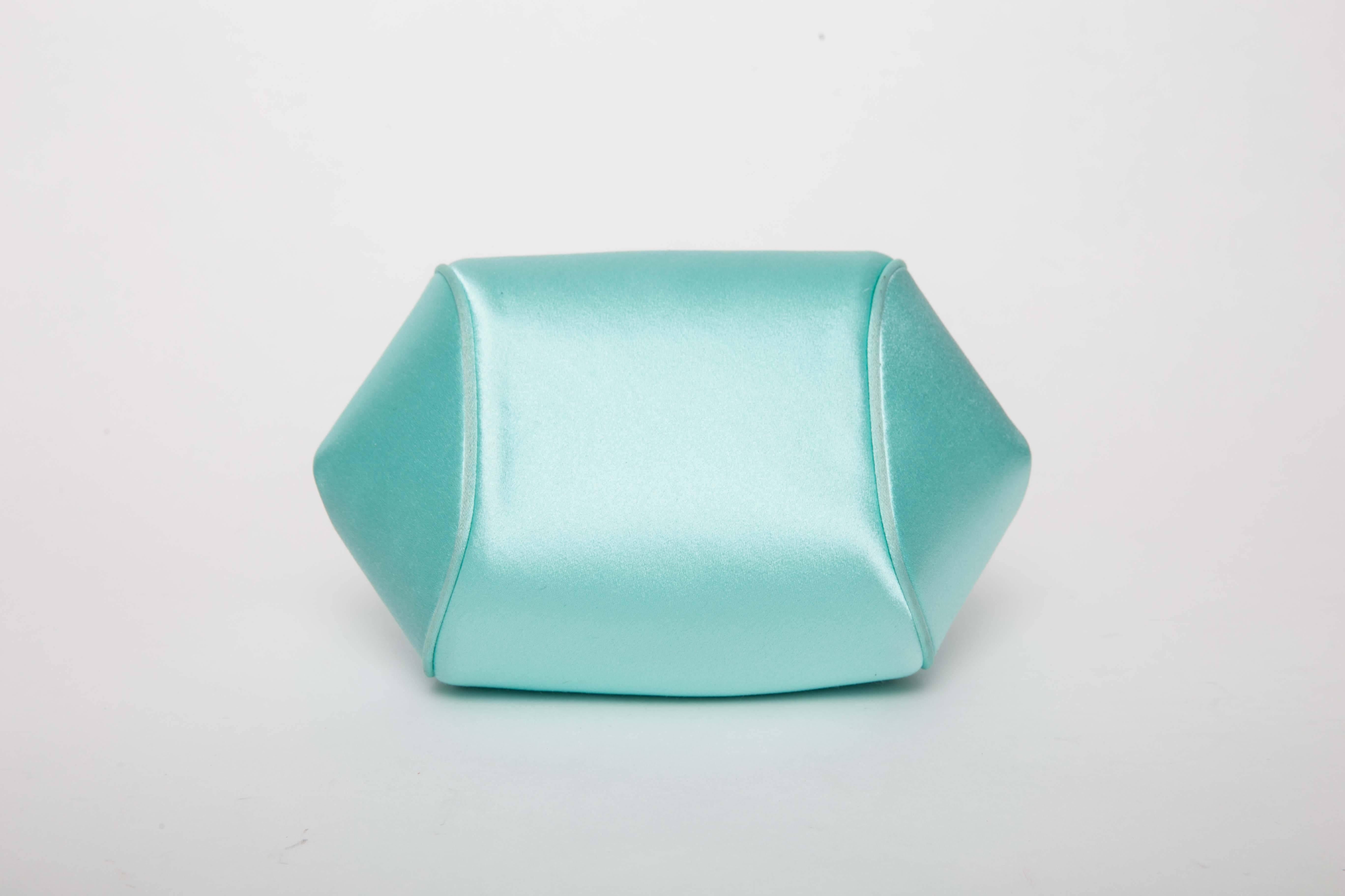 Tiffany & Co. Bracelet Bag in Tiffany Blue features  a satin exterior and palladium-plated solid hardware with silver leather interior lining . Bag has one small flat interior pocket with Tiffany & Co, silver plaque.
Kiss lock closure.
Comes with