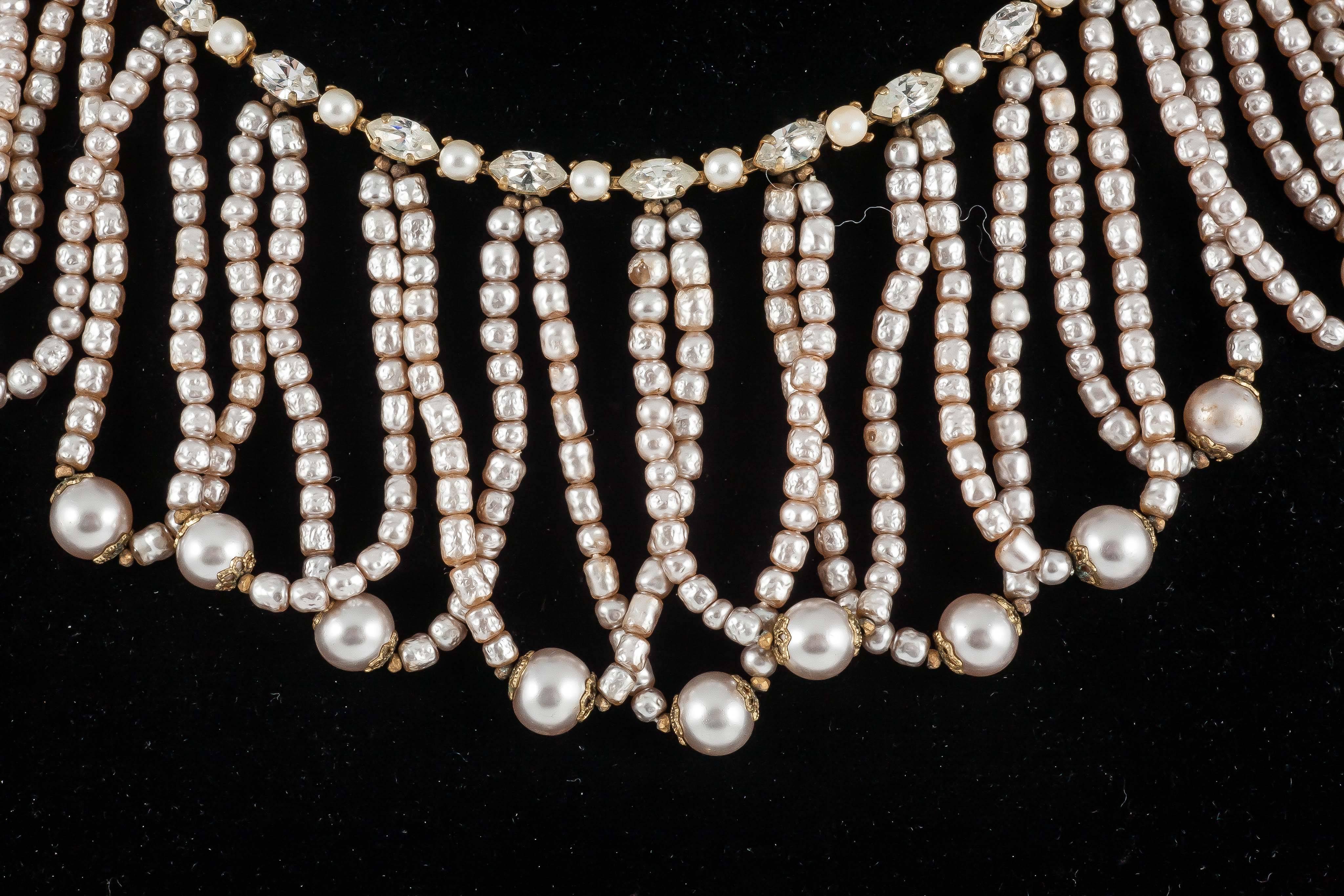 Cascading loops of Haskell's signature material: baroque pearls hanging from a simple mixed row of pearls and clear paste. Each loop ends in a larger baroque pearl, giving the necklace a fine balance and great movement. A gentle and feminine piece.