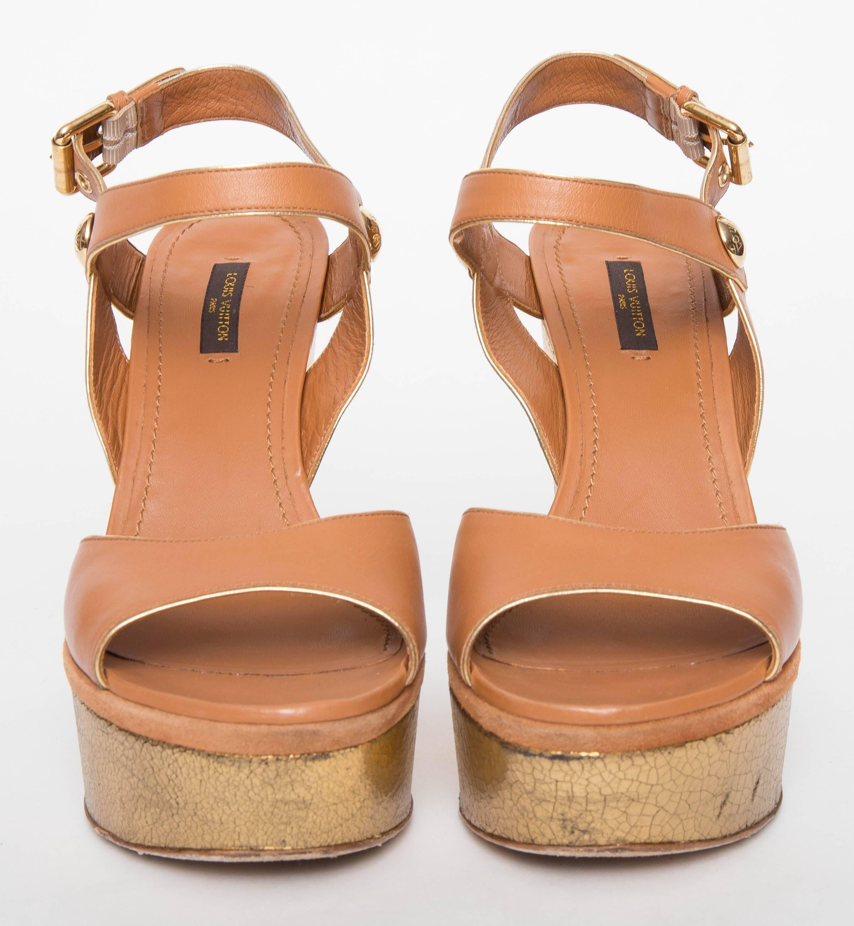 Louise  platform Vuitton Cruise 2013 Liner Sandal in tan leather upper trimmed in gold and gold crackle platforms. Gold toned hardware. Adjustable buckle ankle strap.
Does not come with original box.
