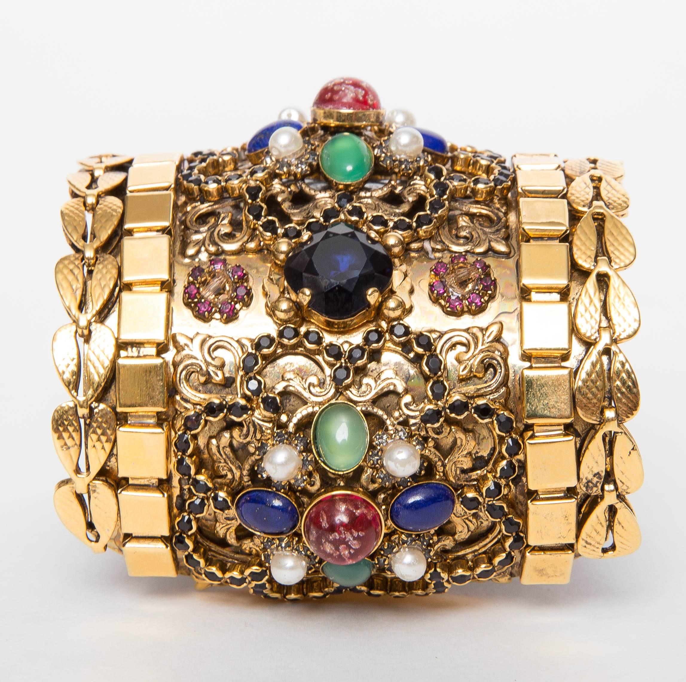 Erickson Beamon Byzantium Cuff features  gold vermeil chains, bubbled cabochons and glass pearls among pavé Swarovski crystals, and intricate filigree. Soft leather backing.
24k gold vermeil.
Does not come with original box.

