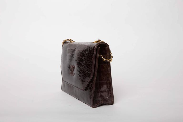 Exceptional Chanel crocodile single flap shoulder bag in a rich brown with gold chain strap. This bag dates from 1989 - 1991. Original authentication card No 1098402 is included. Hologram is intact. 
Lined in brown leather with one zip pocket. 
As
