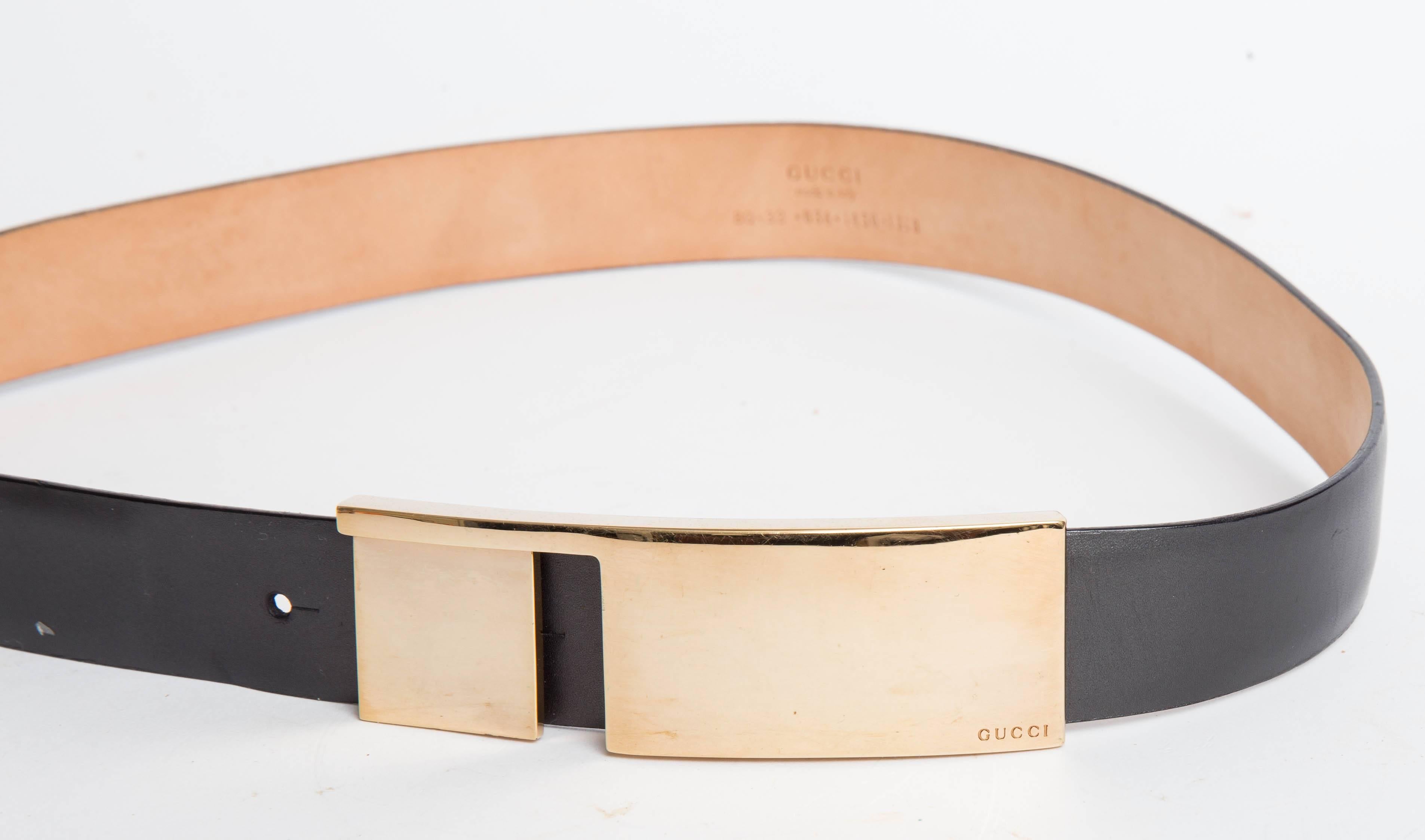 Stunning and sculptural Gucci belt with a very beautiful signed gold clasp. This black leather belt has hints of pearlized grey making the color very subtle and quite beautiful. There are four perforations in the belt allowing adjustments to length