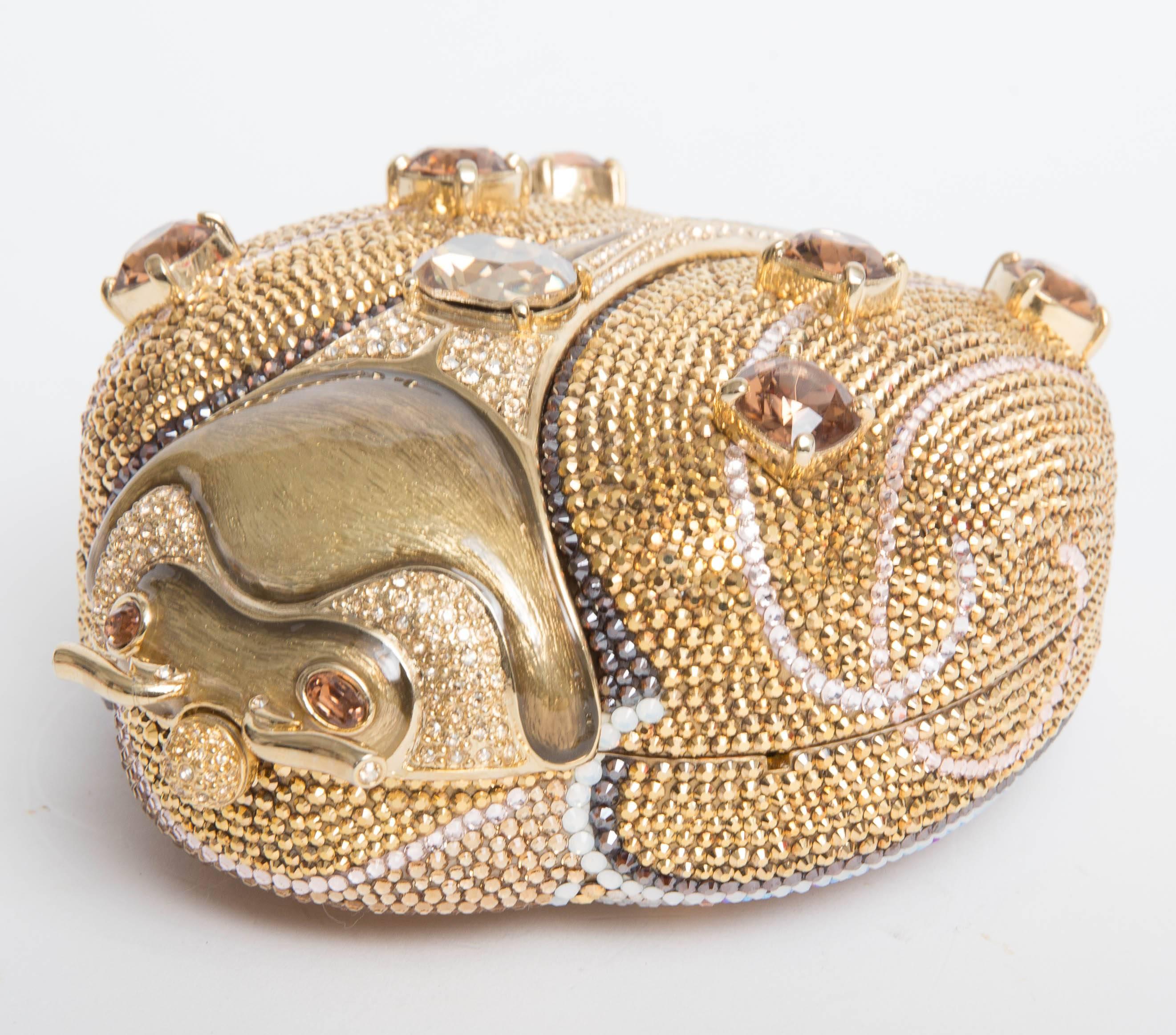 Judith Leiber Gold Tone Beaded Crystal Ladybug Minaudiere.
Limited Edition ladybug minaudiere handbag framed in antique gold and completely covered in aurum( gold dipped) Austrian crystals with large prong set topaz crystals featuring protective