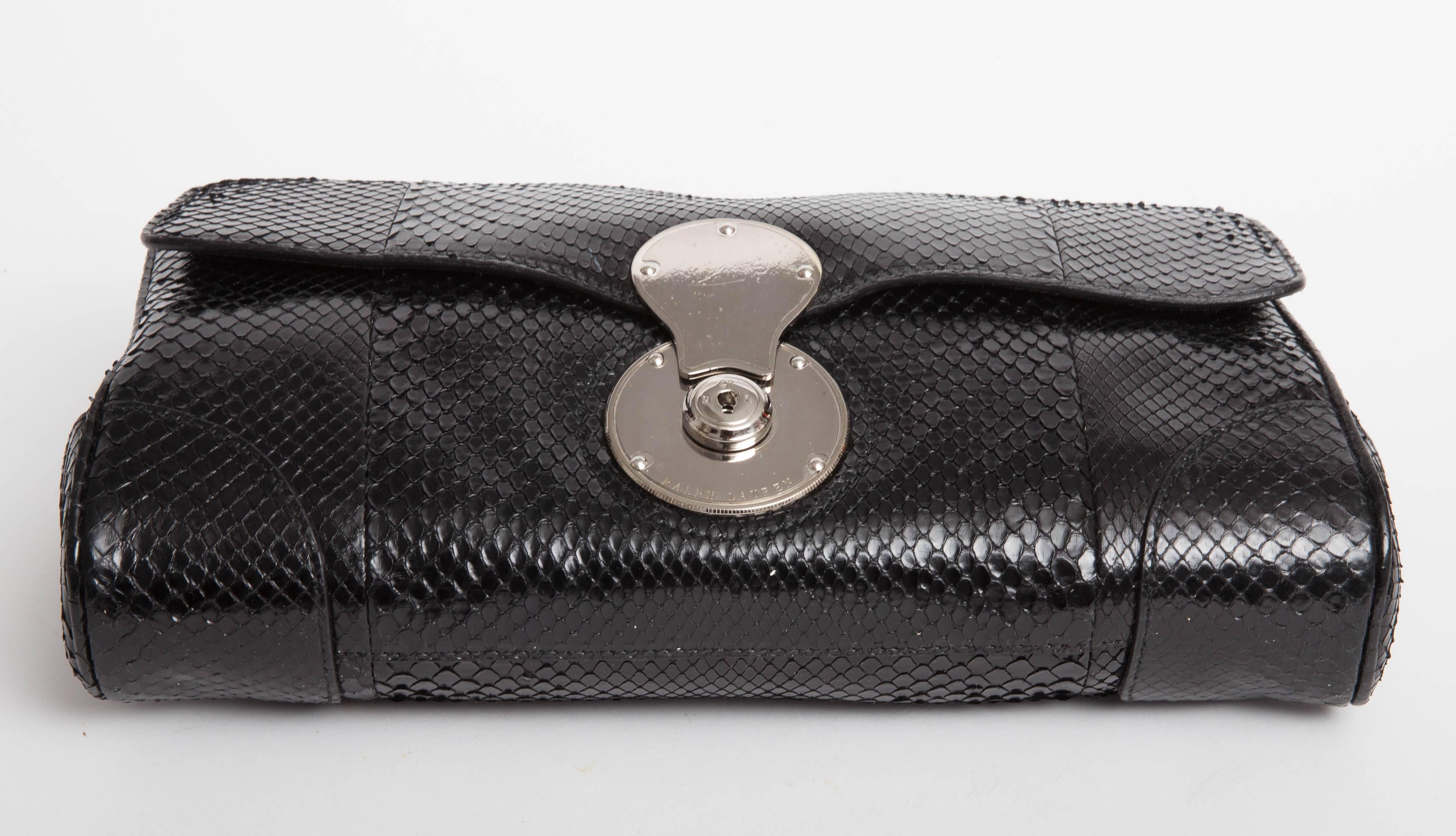 Ralph Lauren Oversize  Monaco Black Python Convertible Clutch features a removable strap that converts to shoulder bag, silver hardware and two interior pockets.

Comes with two original dusters, authenticity card, and original tag.