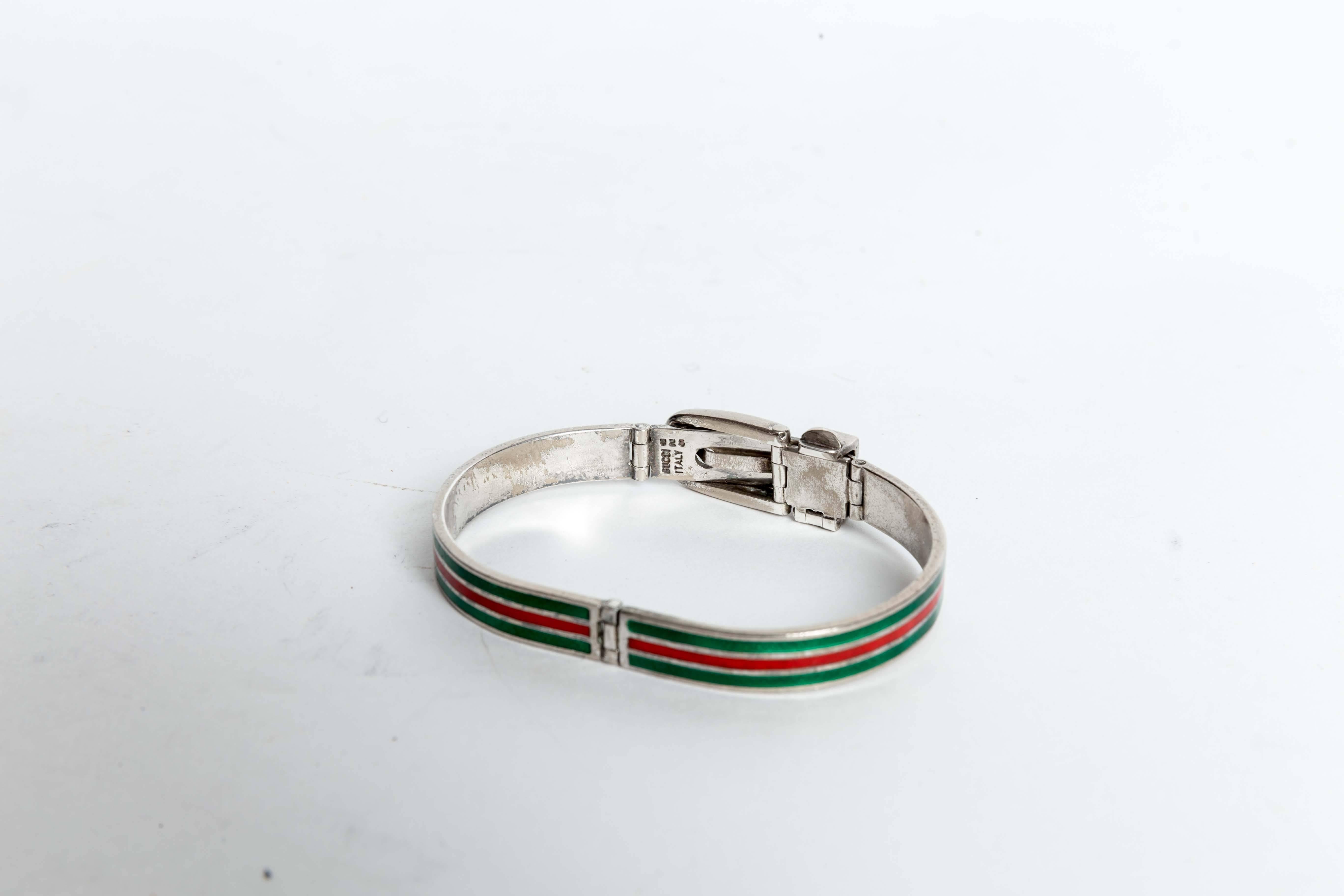 Gorgeous Vintage Gucci Sterling Silver Bracelet with one red and two green enamel stripes. Signed Gucci Italy 925, this bracelet measures 2 1/2 inches when closed. The design features a sterling belt buckle closure.
