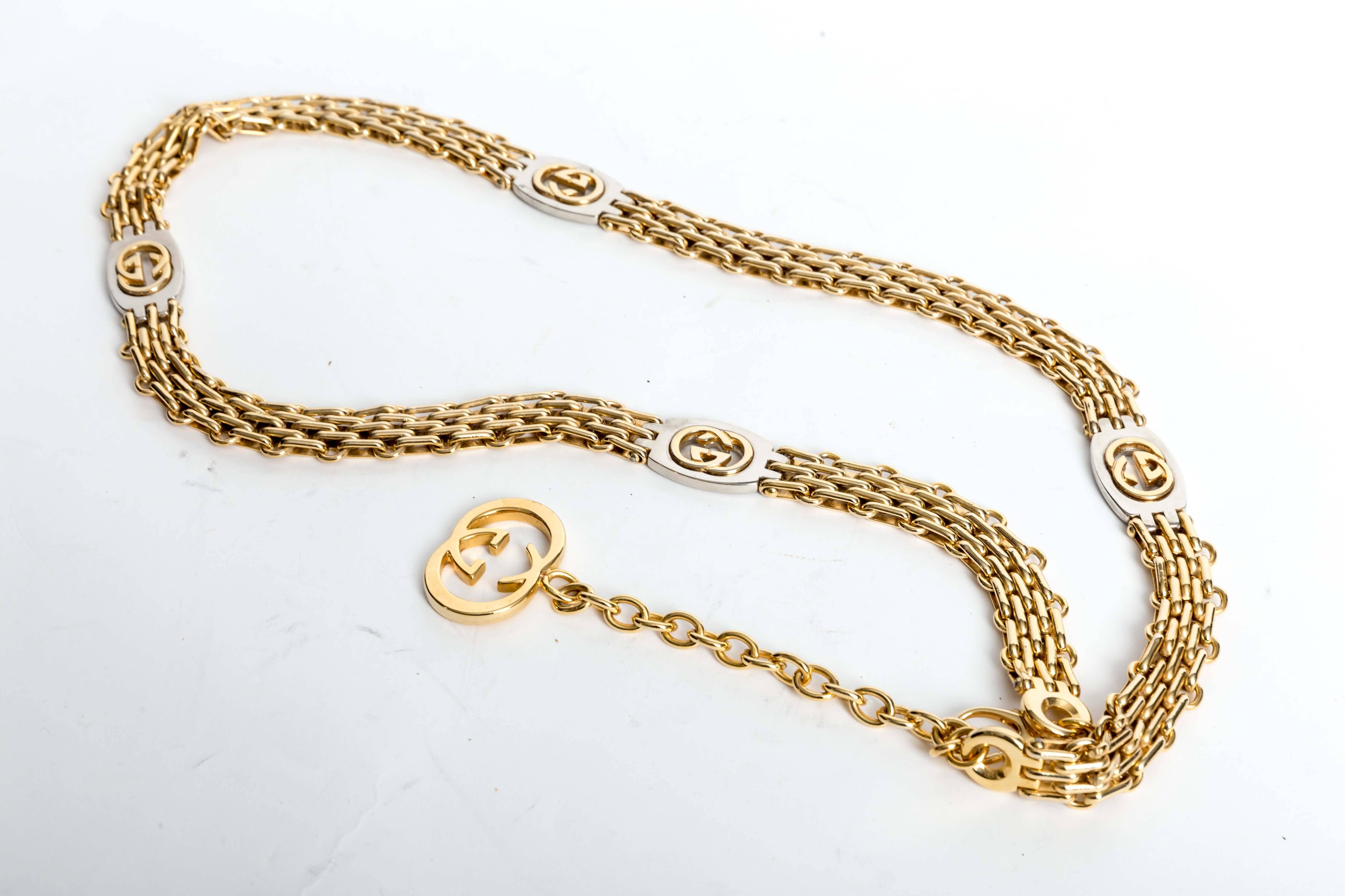 Signed Gucci Made in Italy Vintage Gold Chain Belt with Hanging Gucci Logo Pendant.  This beautiful belt measures 32 inches but can be made shorter,  and the dangling Gucci pendant is 5 inches long. Condition is excellent. There are some scratches