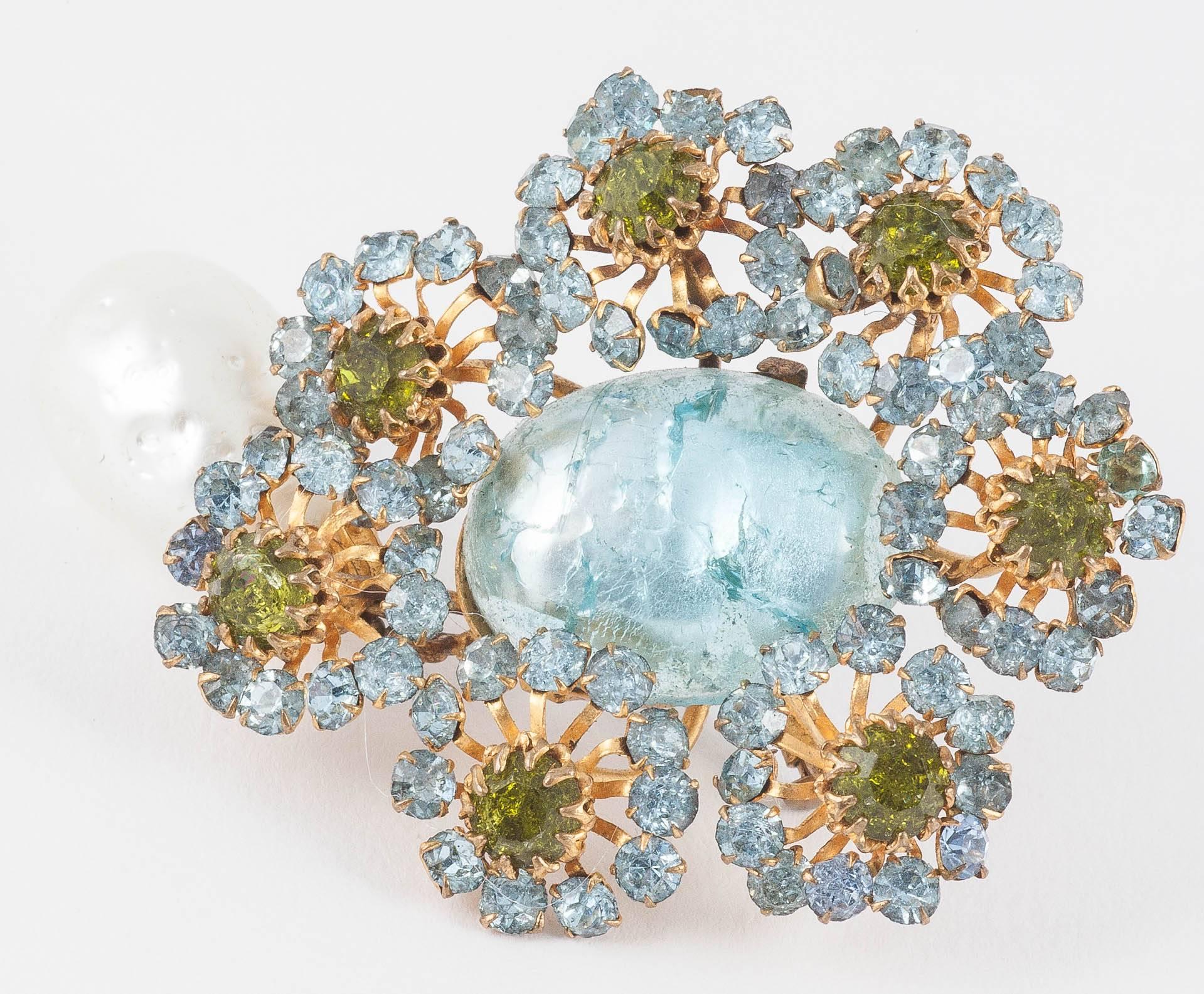 Highly and unusual stylised handmade floral brooch, with a beautiful pendant baroque pearl, suspended from the bottom. Deep chartreuse crackled stones are set amongst soft grey aqua blue stone flowers, surrounding a beautiful large aqua crackle