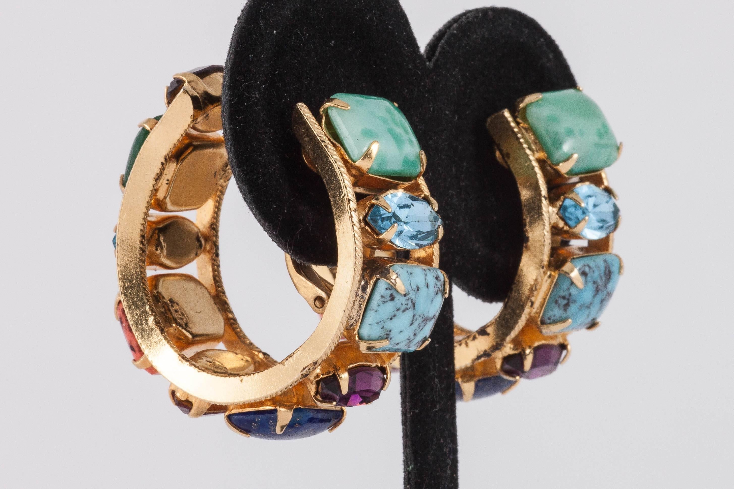 These earrings by favorite maker Henry Schreiner have an ingenious hidden clip which allows the earrings to sit snugly on the lobe without being a pierced hoop. Employing hand set rhinestone and art glass 'stones' in a riot of colour so typical of