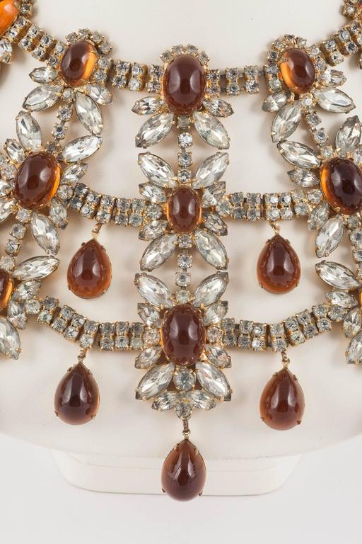 This is the most wonderful Kenneth Jay Lane collar from the height of his creative strengths in the 1960s. It is a huge statement piece! Made of clear paste and topaz cabuchons (both fixed and pedant), which are cast in resin (this would be to heavy