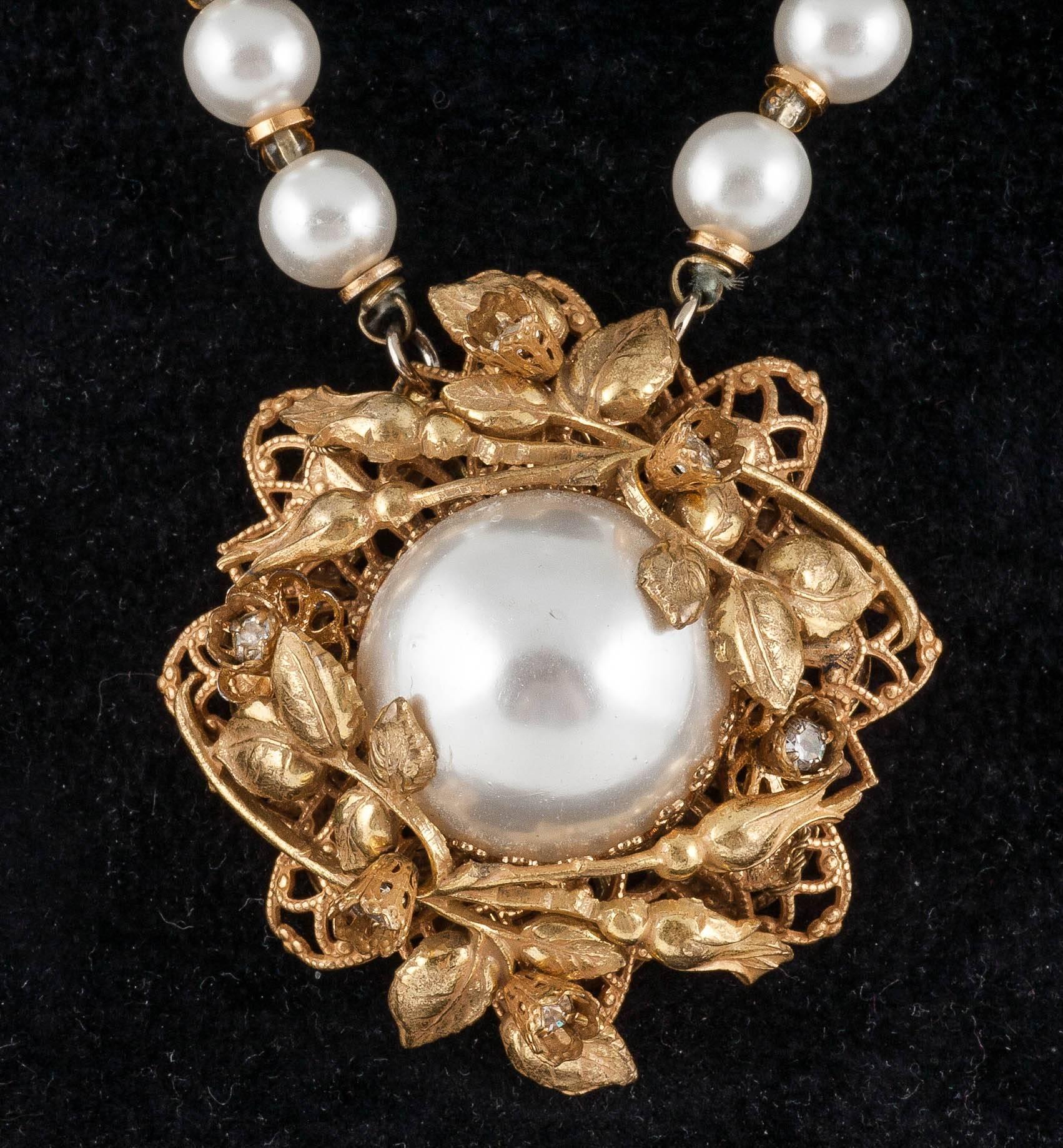 This lovely super wearable pendant necklace is made with glass faux pearls which makes it very light The soft Russian gilt flowers have lovely rhinestone insets which give little glints dotted all over the pendant. The gilt spacers between the