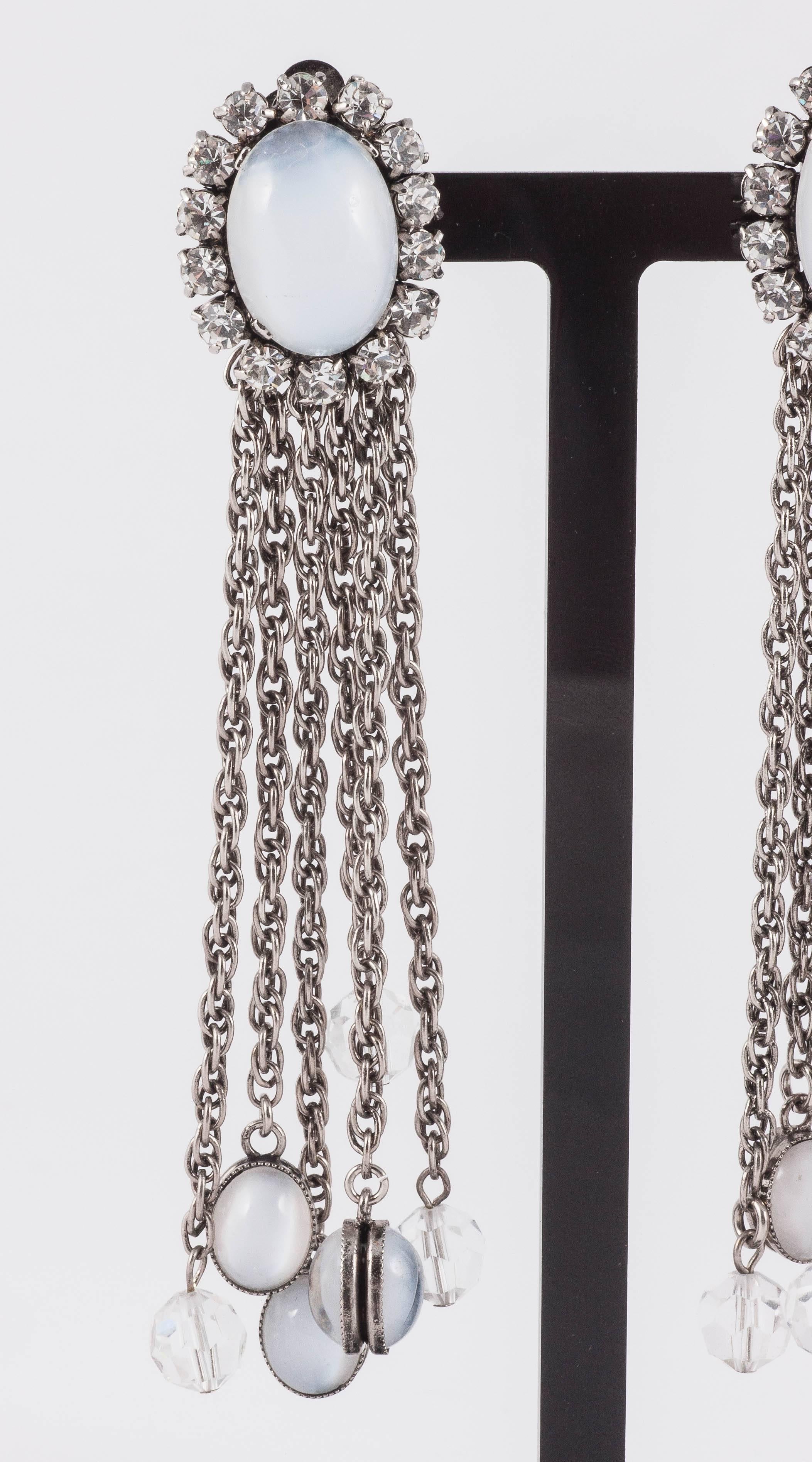 Not signed, but made in Germany in the early 1970s, these earrings have a really modern sensibility due to the hanging crystals and opaline orbs suspended from chains. Both debutante and punk in equal measure wear these with a ball gown or a leather