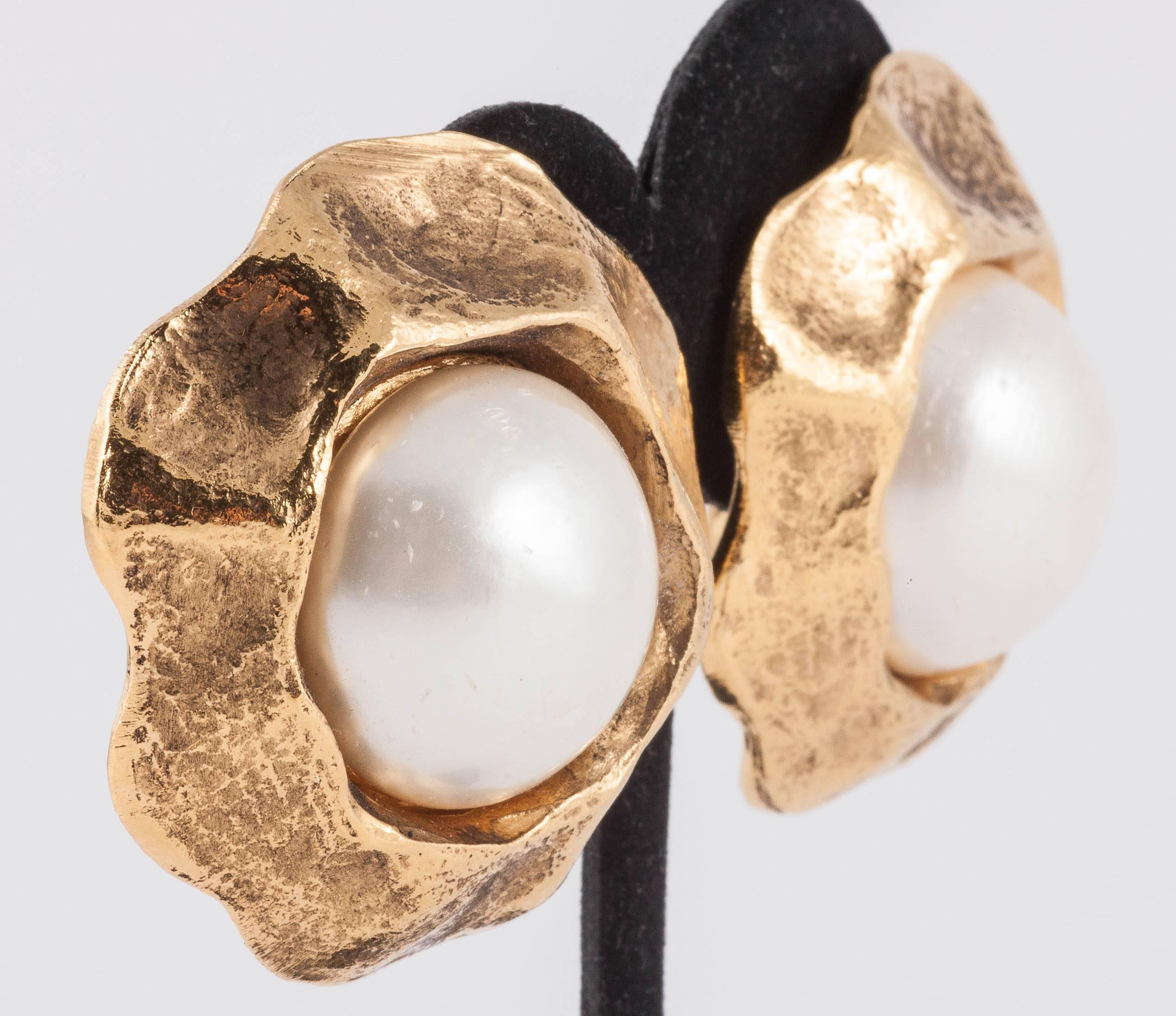These earrings are classic of Chanel of the 1980s. A really strong statement pair of earrings but with a lovely stylised flower like shape, these have a very rich colour of gilding. When worn, they sit snug to the ear and frame the face beautifully.