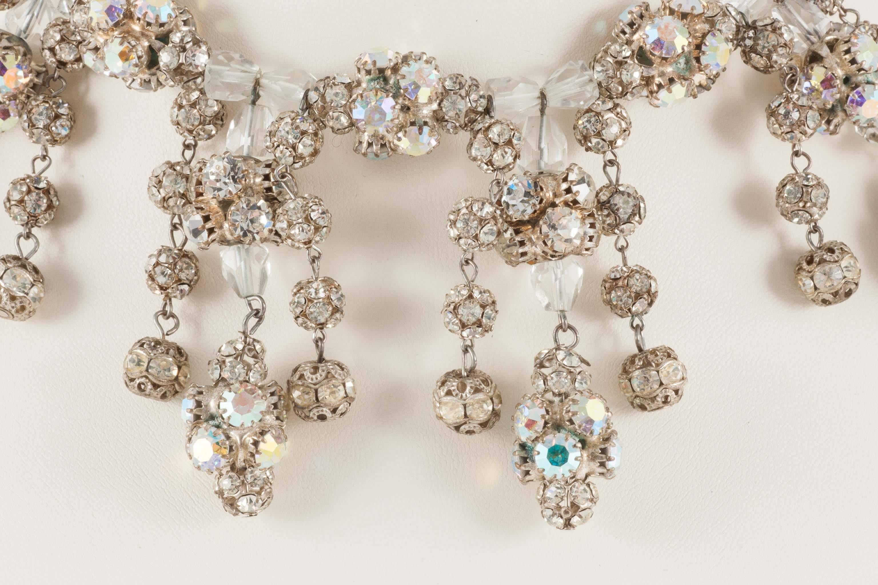 This lovely clear crystal and rhinestone roundel necklace is a delight to wear. It has the 'en tremblant' quality as the paste  balls of hand set crystals hang from the clear crystal collar and shimmer as you move. It has a small and charming clasp